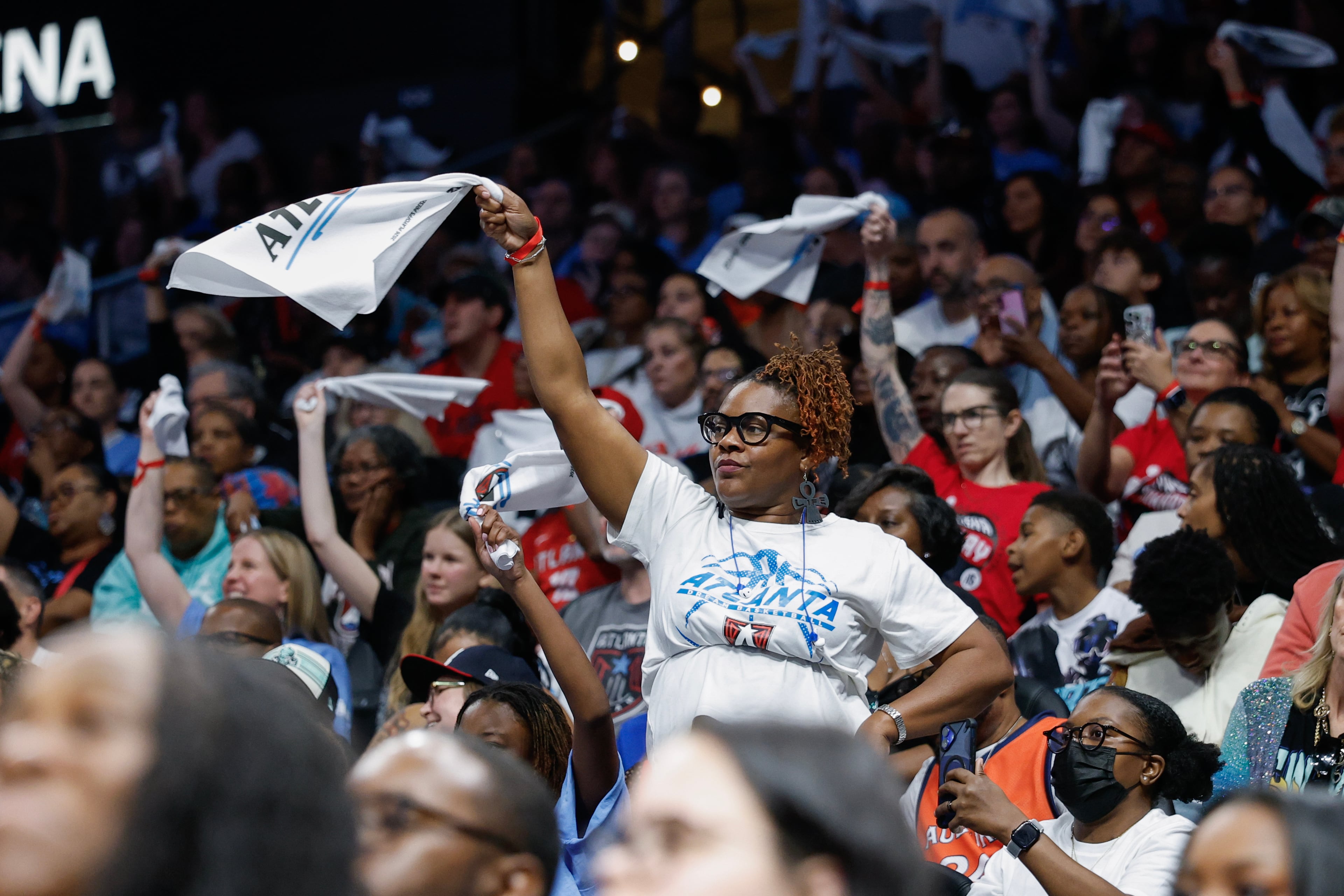 Fans wave rally towels during the second half of a WNBA semifinal playoff game 1 between the Atlanta Dream and the New York Liberty, Sunday, Oct. 4, 2026, in Atlanta. (Erik S. Lesser for the AJC)