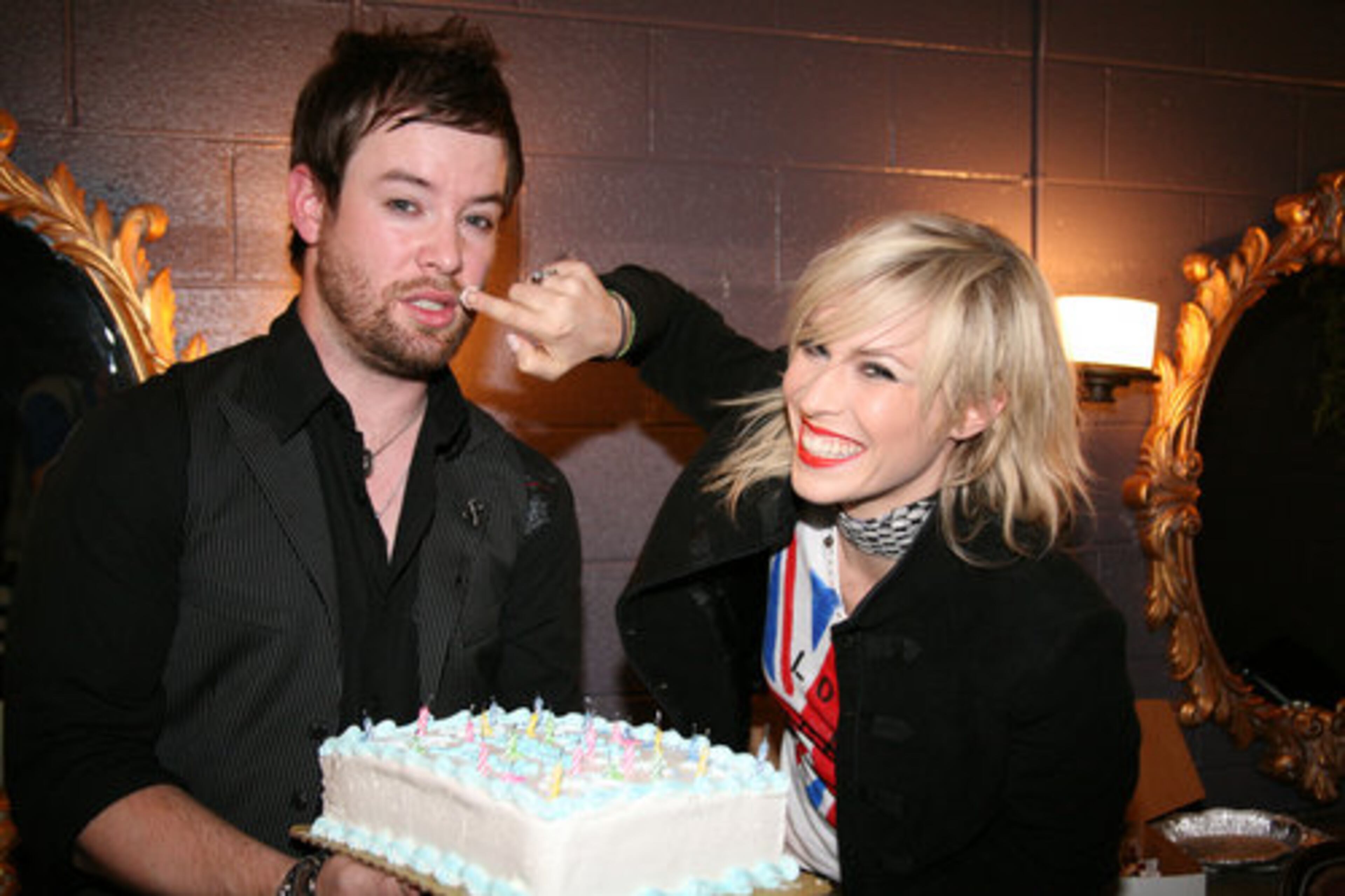 David Cook was surprised onstage in the middle of his set by a birthday cake, courtesy of Q100's Bert Show. Backstage after his performance, Natasha Bedingfield gives David some icing and a birthday greeting.