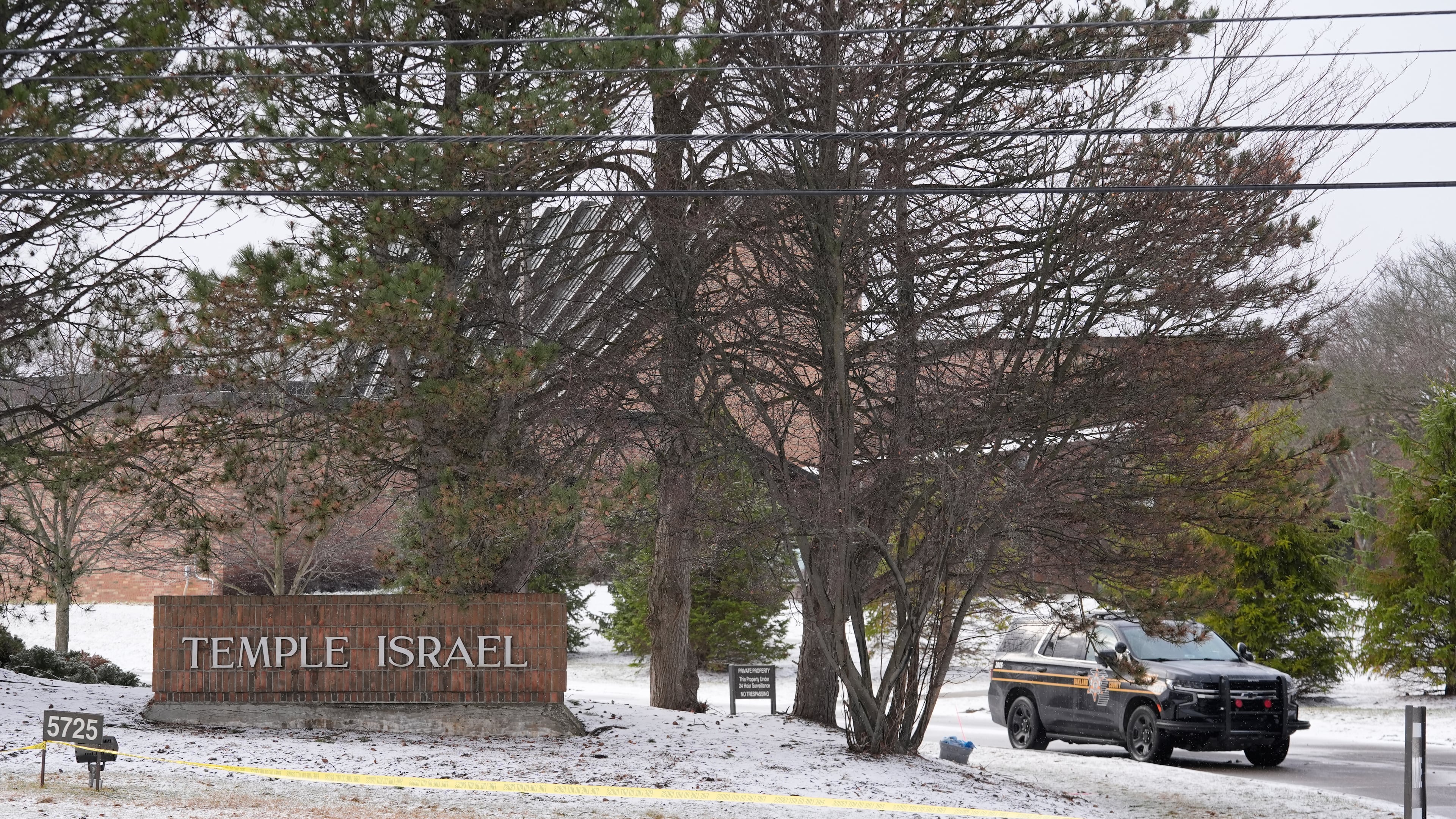 A police vehicle sits outside the Temple Israel synagogue Friday, March 13, 2026, in West Bloomfield Township, Mich. (AP Photo/Paul Sancya)