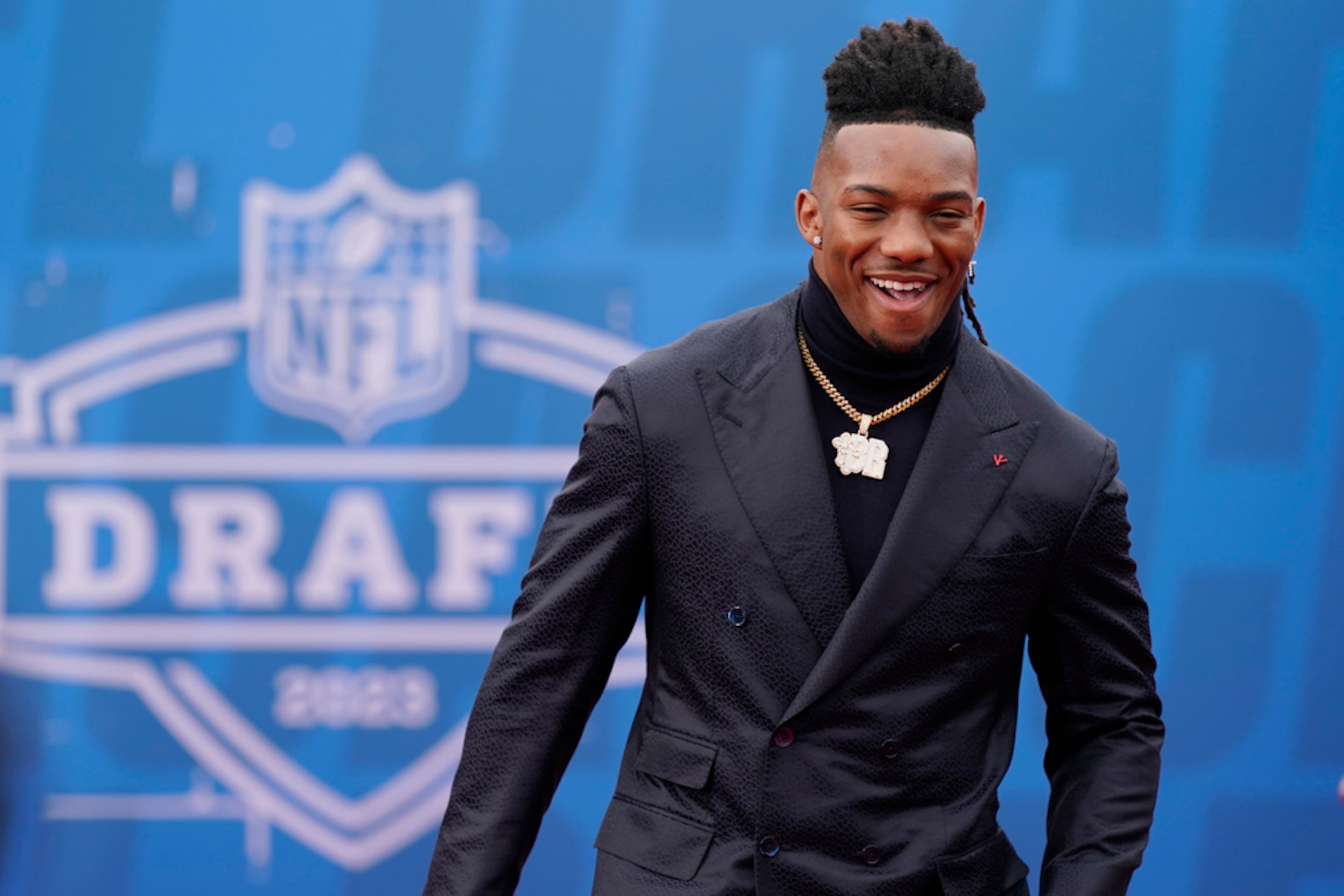 Texas running back Bijan Robinson arrives on the red carpet before the first round of the NFL football draft, Thursday, April 27, 2023, in Kansas City, Mo. (AP Photo/Charlie Riedel)