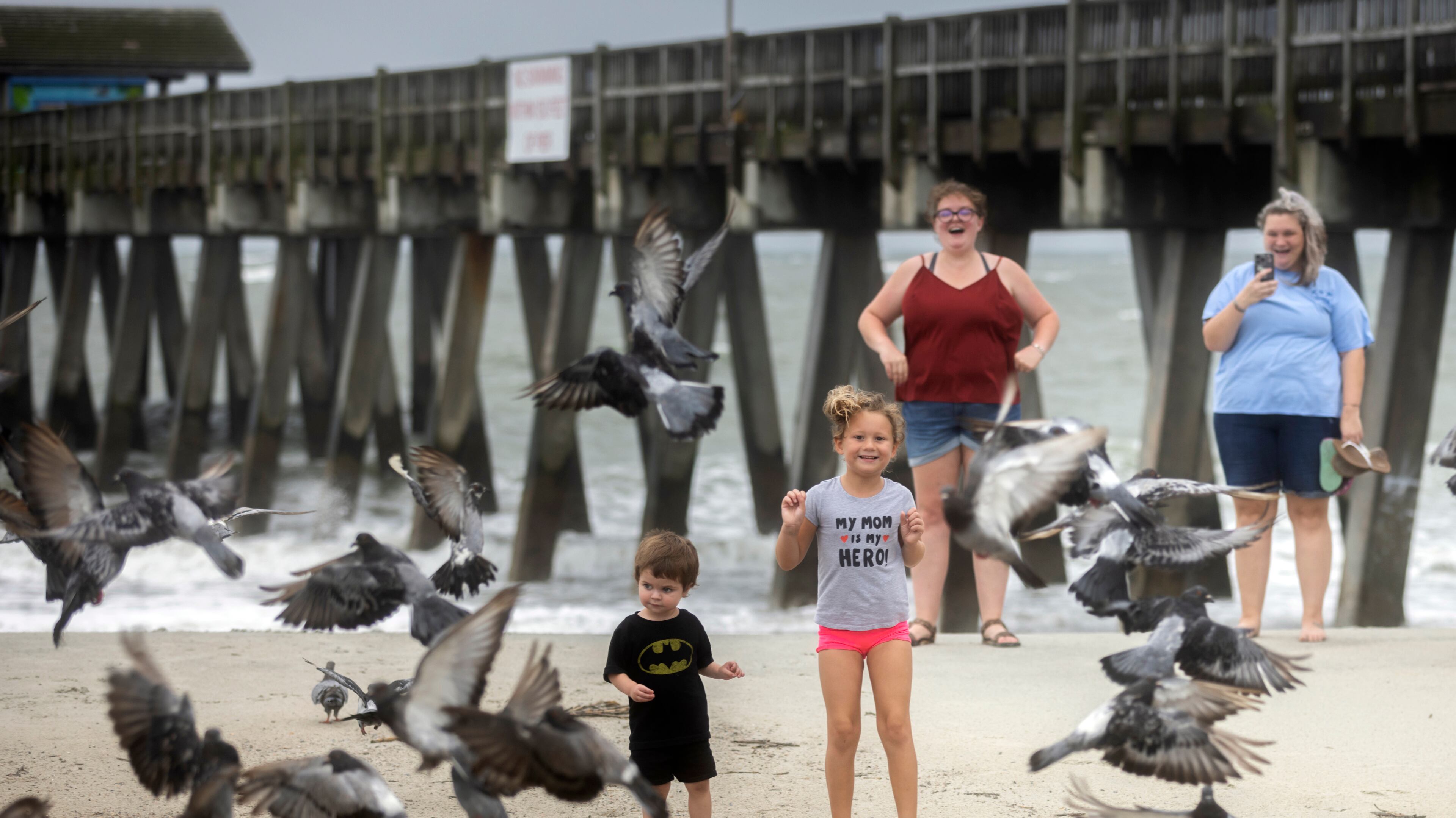 TYBEE ISLAND, GA - AUGUST 30, 2023:
Emma Martin of Tybee Island runs towards a group of pigeons on the beach near the Tybee Pier as Hurricane Idalia moves through the state, Wednesday, Aug. 30, 2023, in Tybee Island, Ga. The system remained a hurricane as it crossed into Georgia with top winds of 90 mph after drenching Florida mostly to the east of Tallahassee. (AJC Photo/Stephen B. Morton)