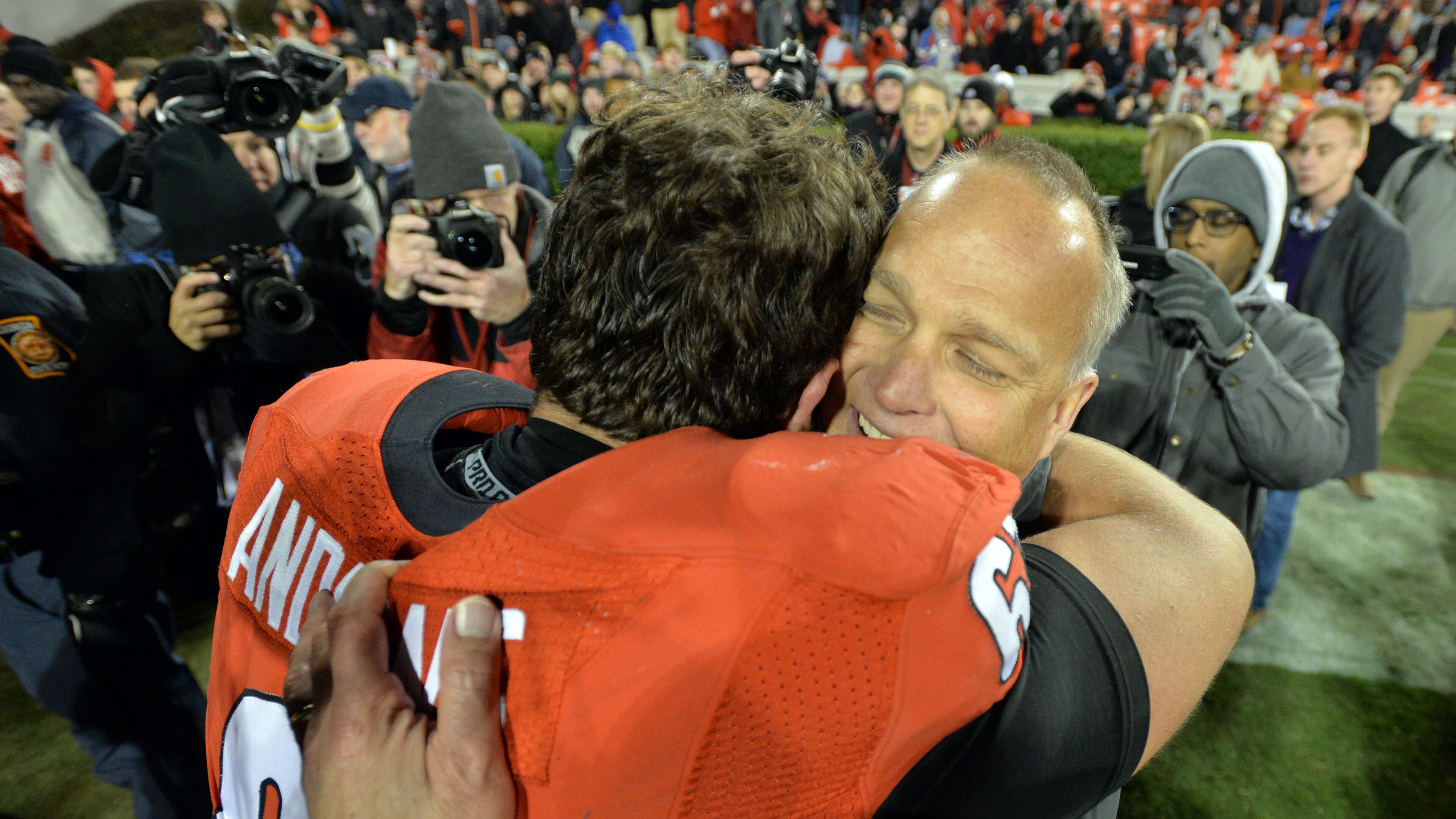 Georgia head coach Mark Richt celebrates the Bulldogs' win over Auburn with center David Andrews in 2014. BRANT SANDERLIN / BSANDERLIN@AJC.COM
