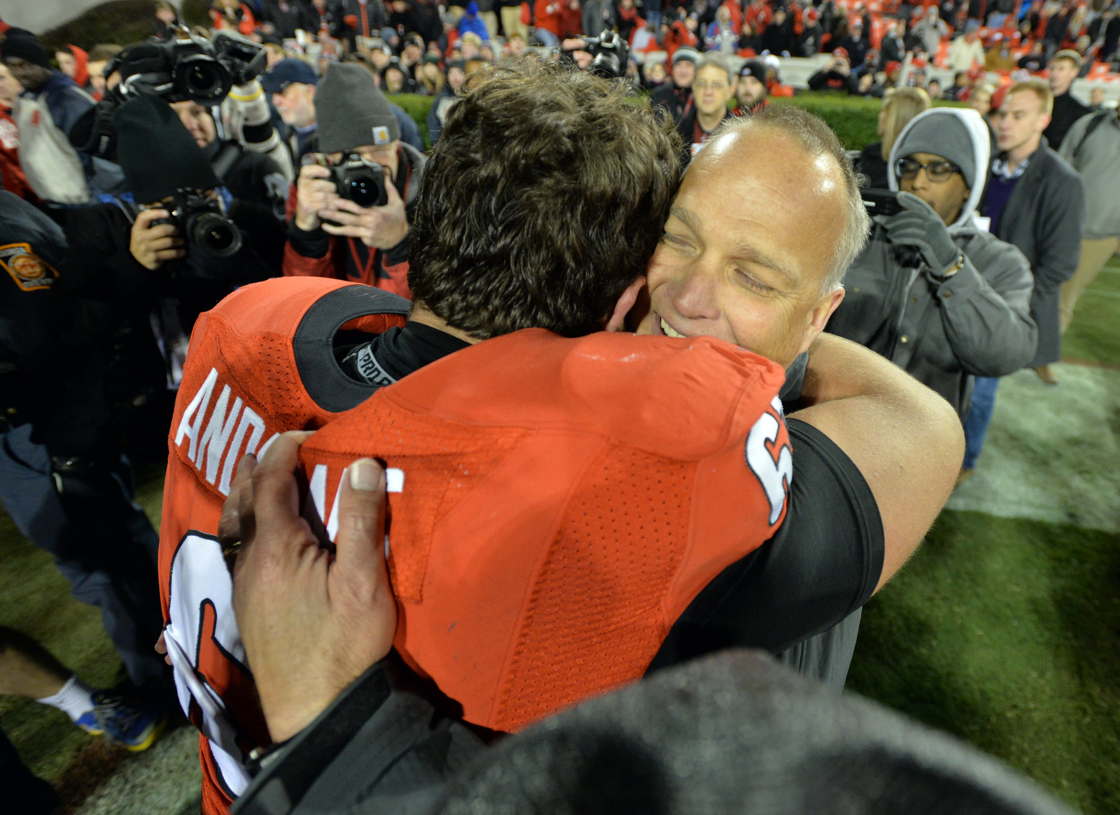 Georgia head coach Mark Richt celebrates the Bulldogs' win over Auburn with center David Andrews in 2014. BRANT SANDERLIN / BSANDERLIN@AJC.COM