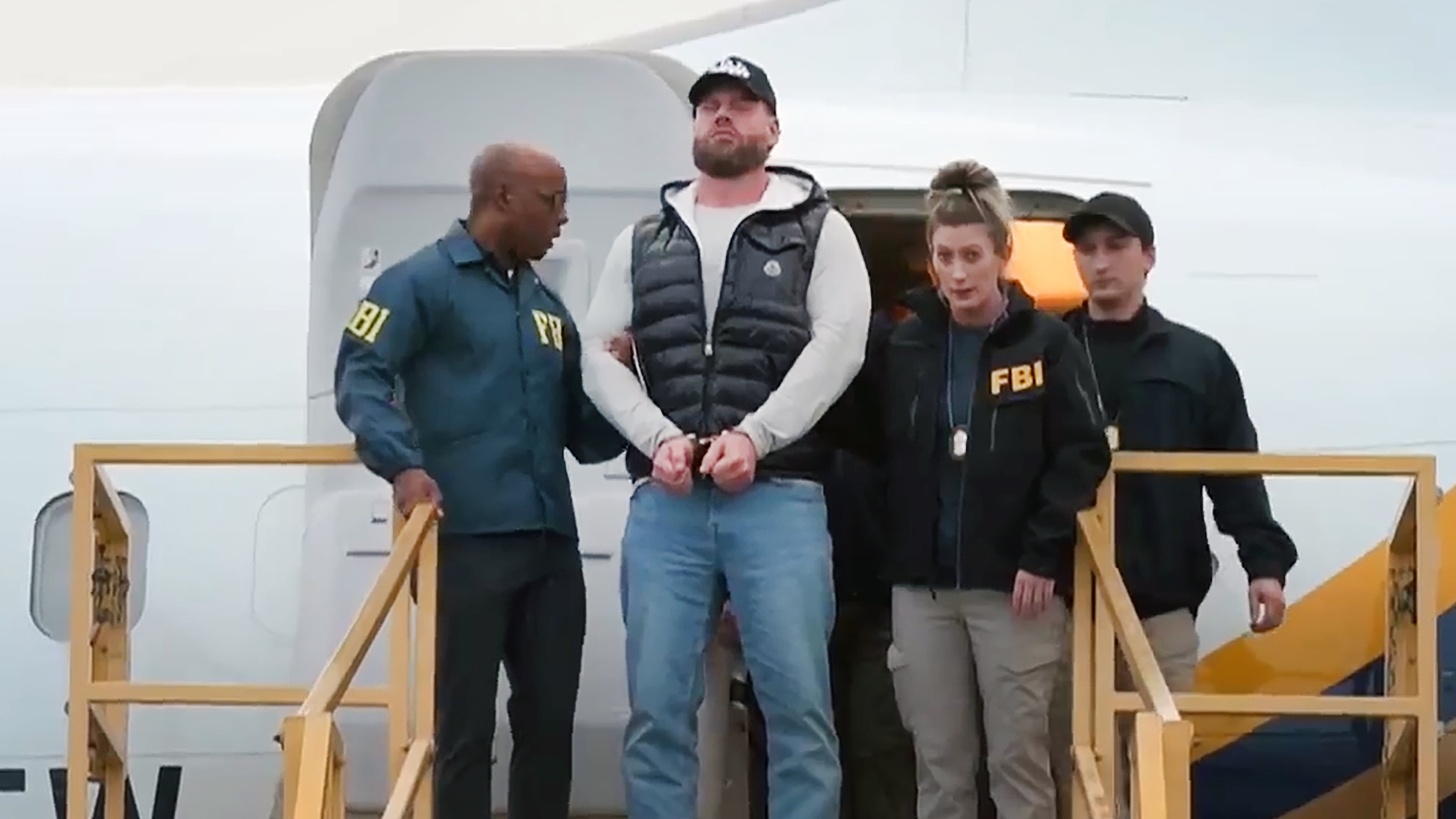 This still photo taken from video and provided by the FBI shows Ryan Wedding a former Canadian Olympic snowboarder facing charges related to drug trafficking and the killing of a federal witness is taken off a plane at Ontario International Airport in Ontario, Calif. on Friday, Jan. 23, 2026. (FBI via AP)