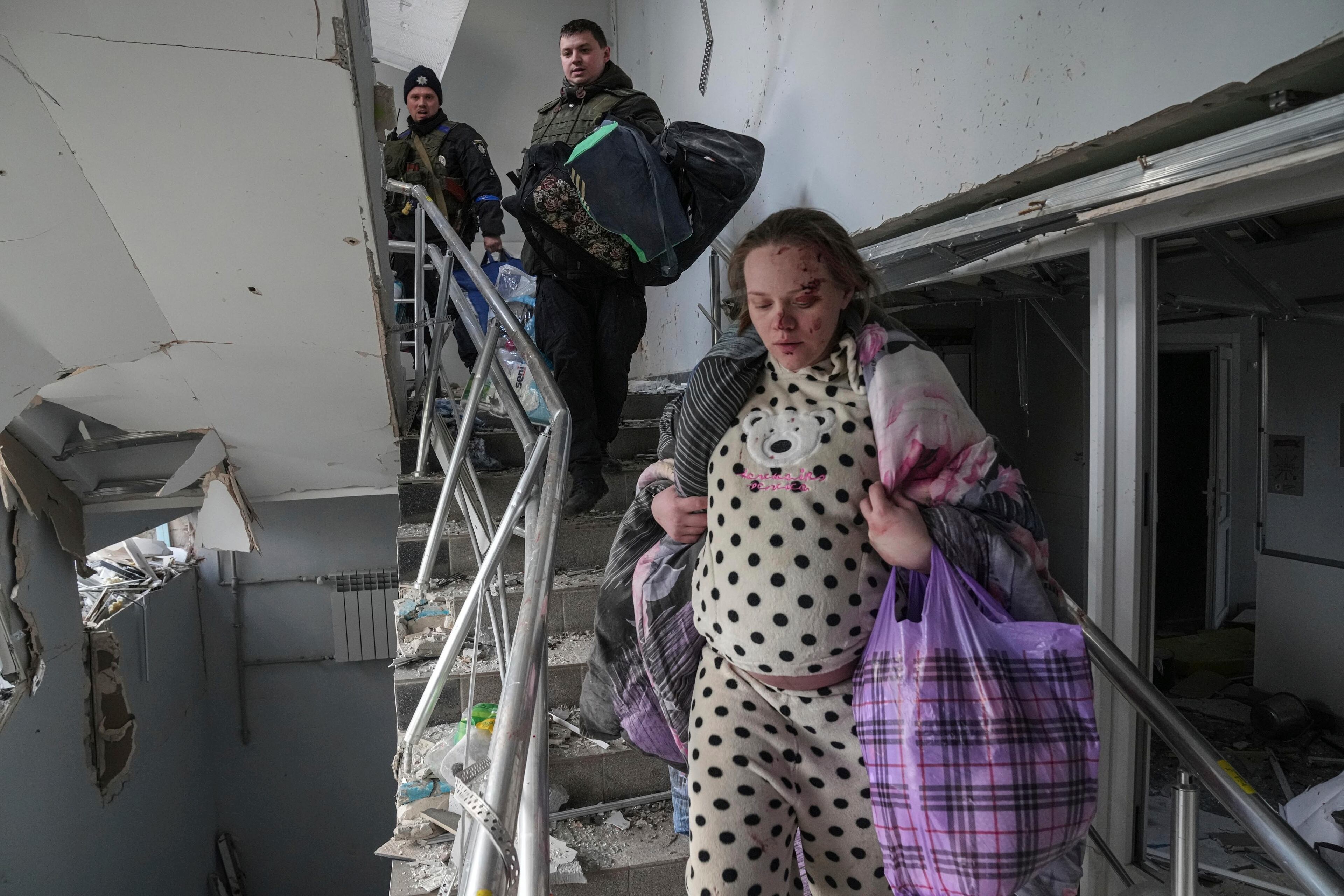 Two other expectant mothers survived, along with their newborn daughters. - Mariana Vishegirskaya walks downstairs at a maternity hospital damaged by shelling in Mariupol, Ukraine, March 9, 2022. Vishegirskaya survived the shelling and later delivered a baby girl in another hospital. (AP Photo/Evgeniy Maloletka)