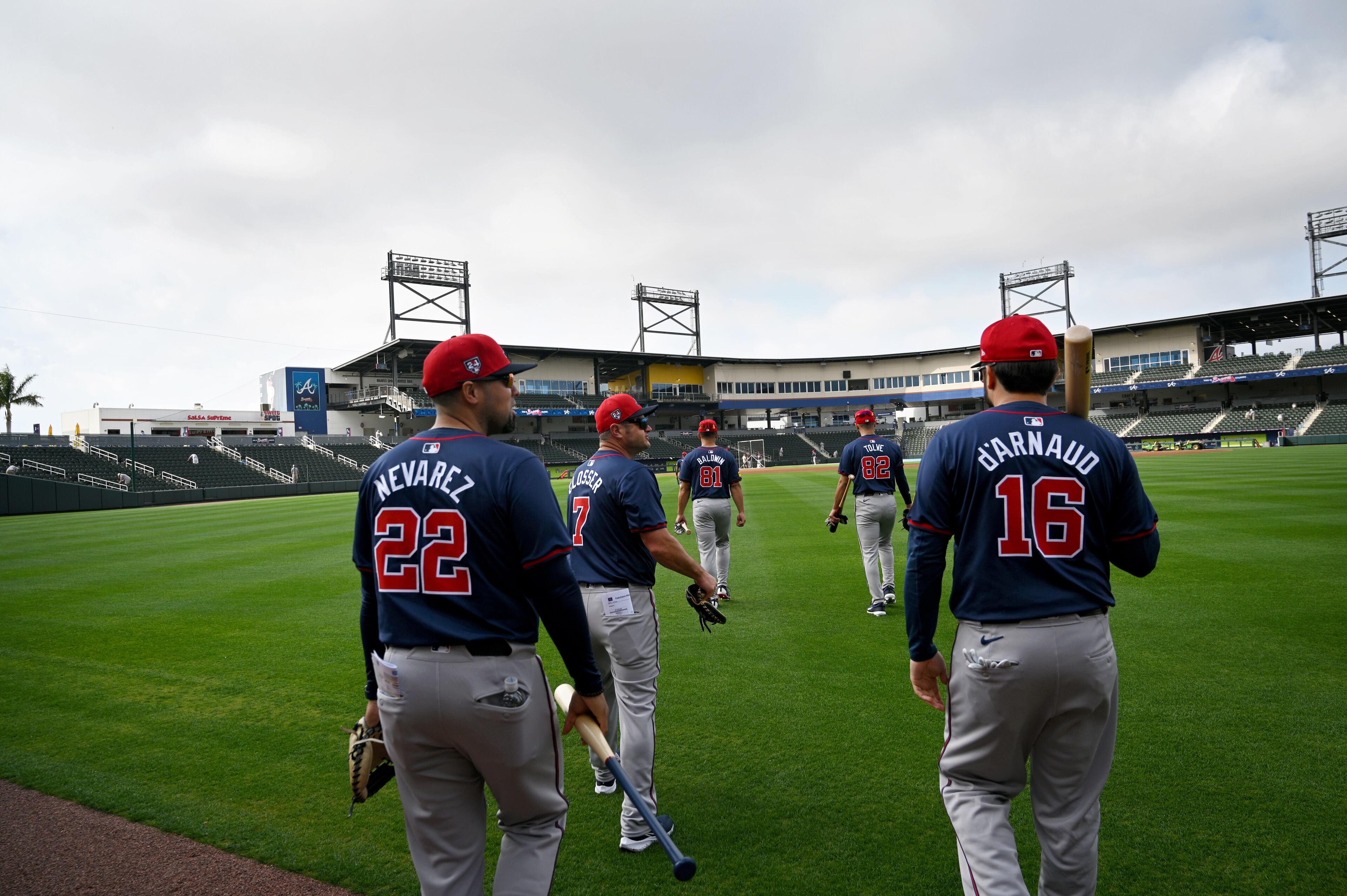 Atlanta Braves catchers walk onto the baseball field for batting practice during spring training workouts at CoolToday Park, Saturday, February, 17, 2024, in North Port, Florida. (Hyosub Shin / Hyosub.Shin@ajc.com)
