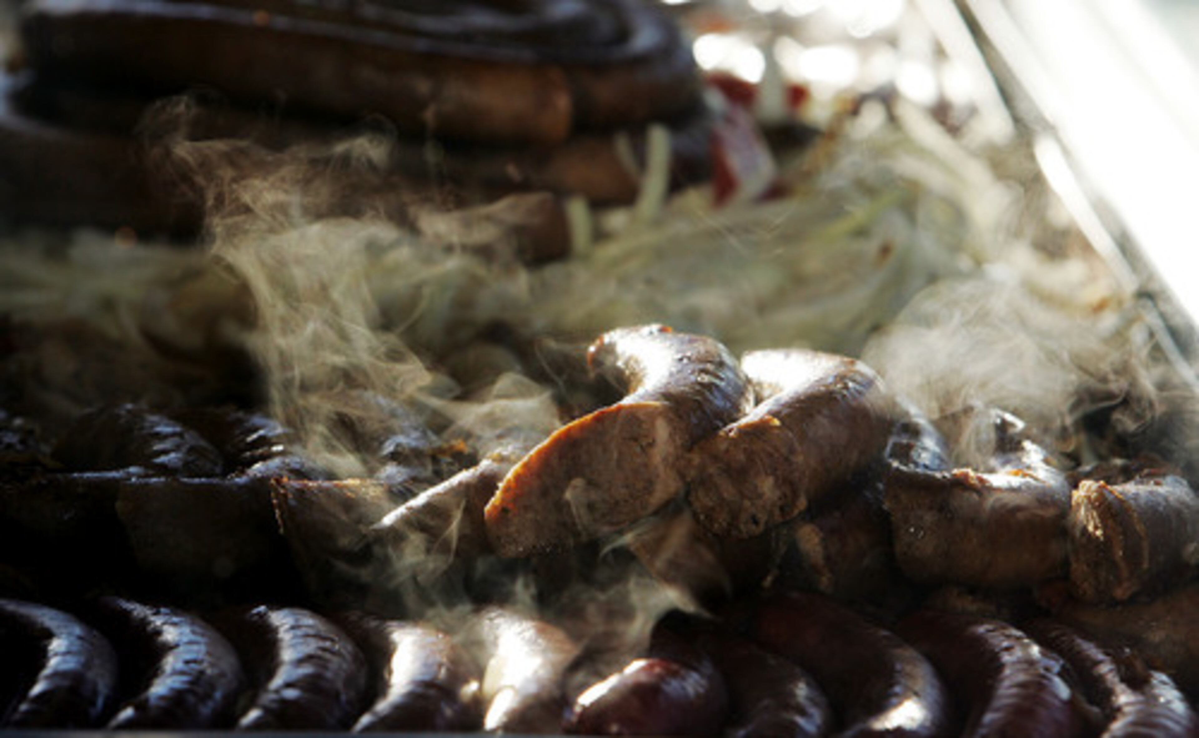 And a fair isn't complete without food. Steam rolls off a row of sausage on a vendor's grill.
