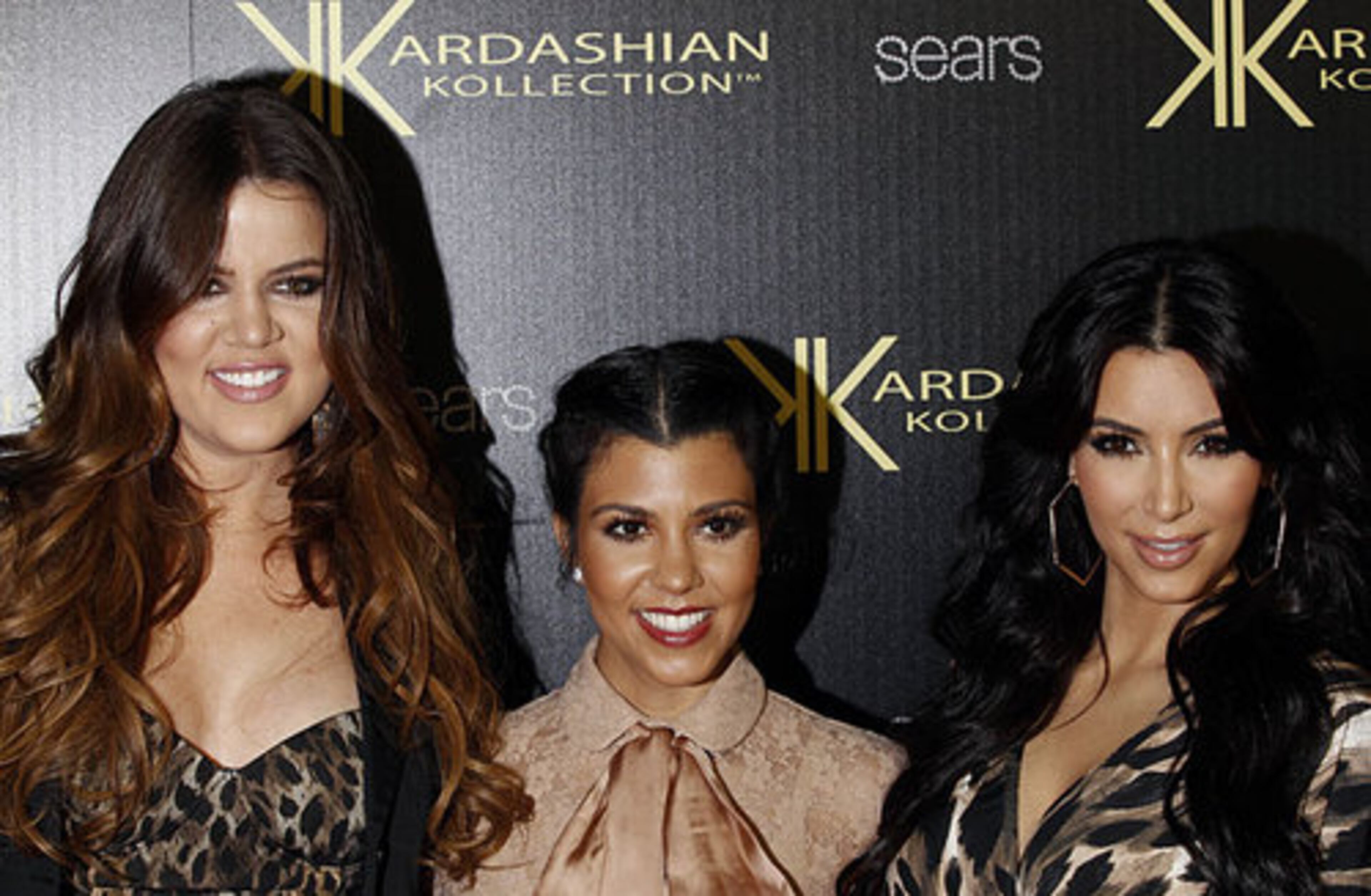 Khloe Kardashian, left, Kourtney Kardashian, center, and Kim Kardashian arrive at the Kardashian Kollection launch party in Los Angeles. The pieces - especially the curve hugging cut out stretch dresses - really look like what Kim, Kourtney and Khloe wear.