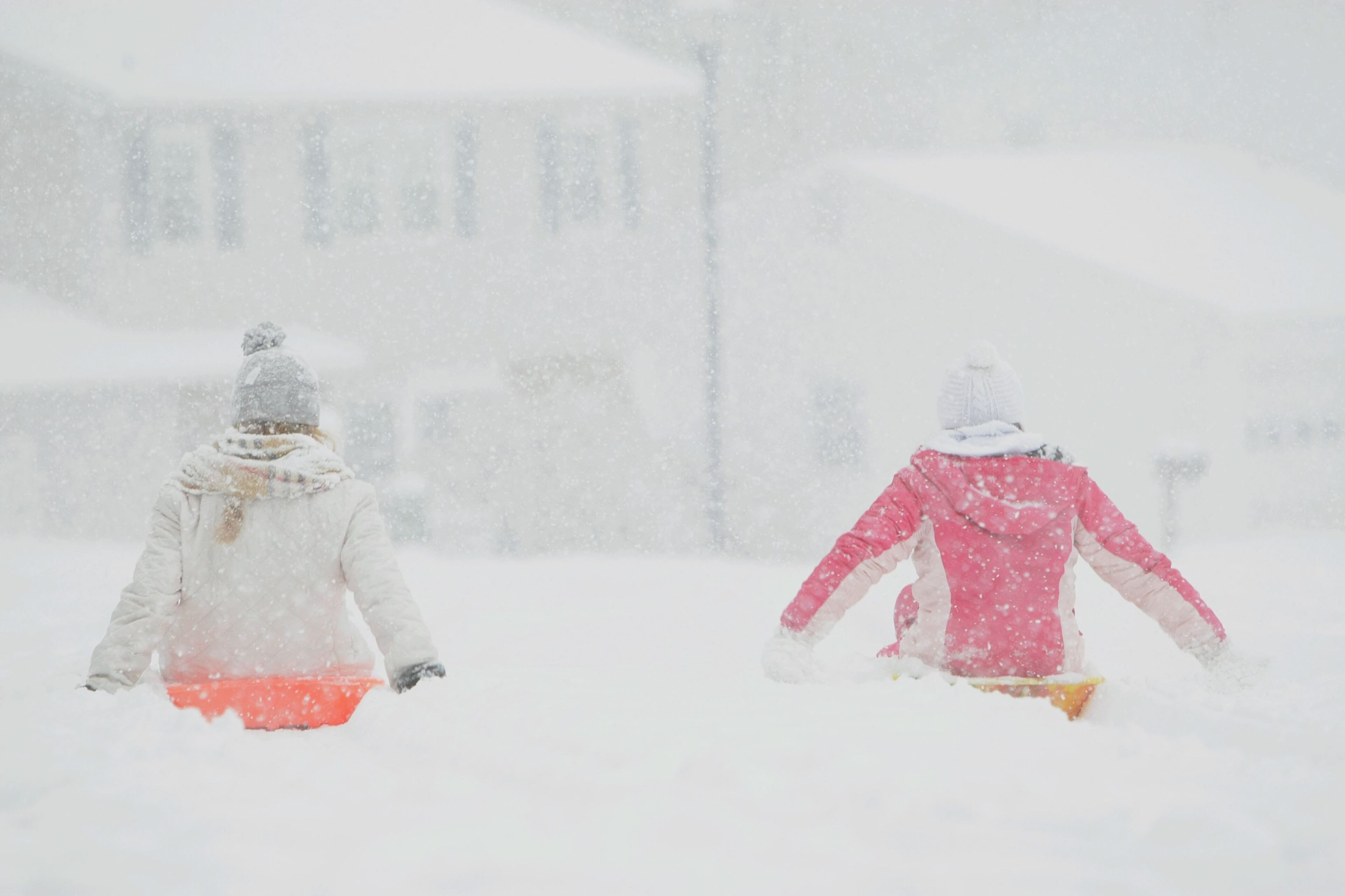 Madison Pierce (left), 13, and Gracie Maher, 11, slowly slide along their neighborhood streets as the first snow of the season rolls into Hockessin, Del. and the region, Sunday, Dec. 8, 2013.