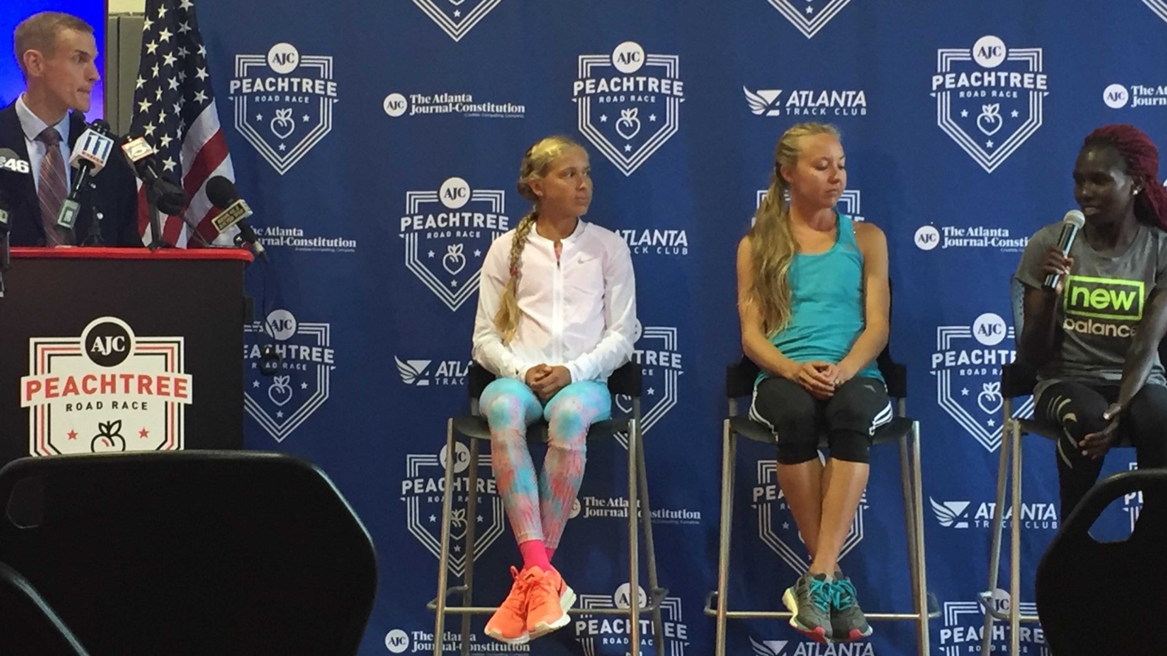 Jay Holder, Atlanta Track Club director of marketing, speaks with (left to right) Jordan Hasay, Neely Gracey and Aliphine Tuliamuk at a press conference Monday. The trio is among the women invited to the 2017 AJC Peachtree Road Race.