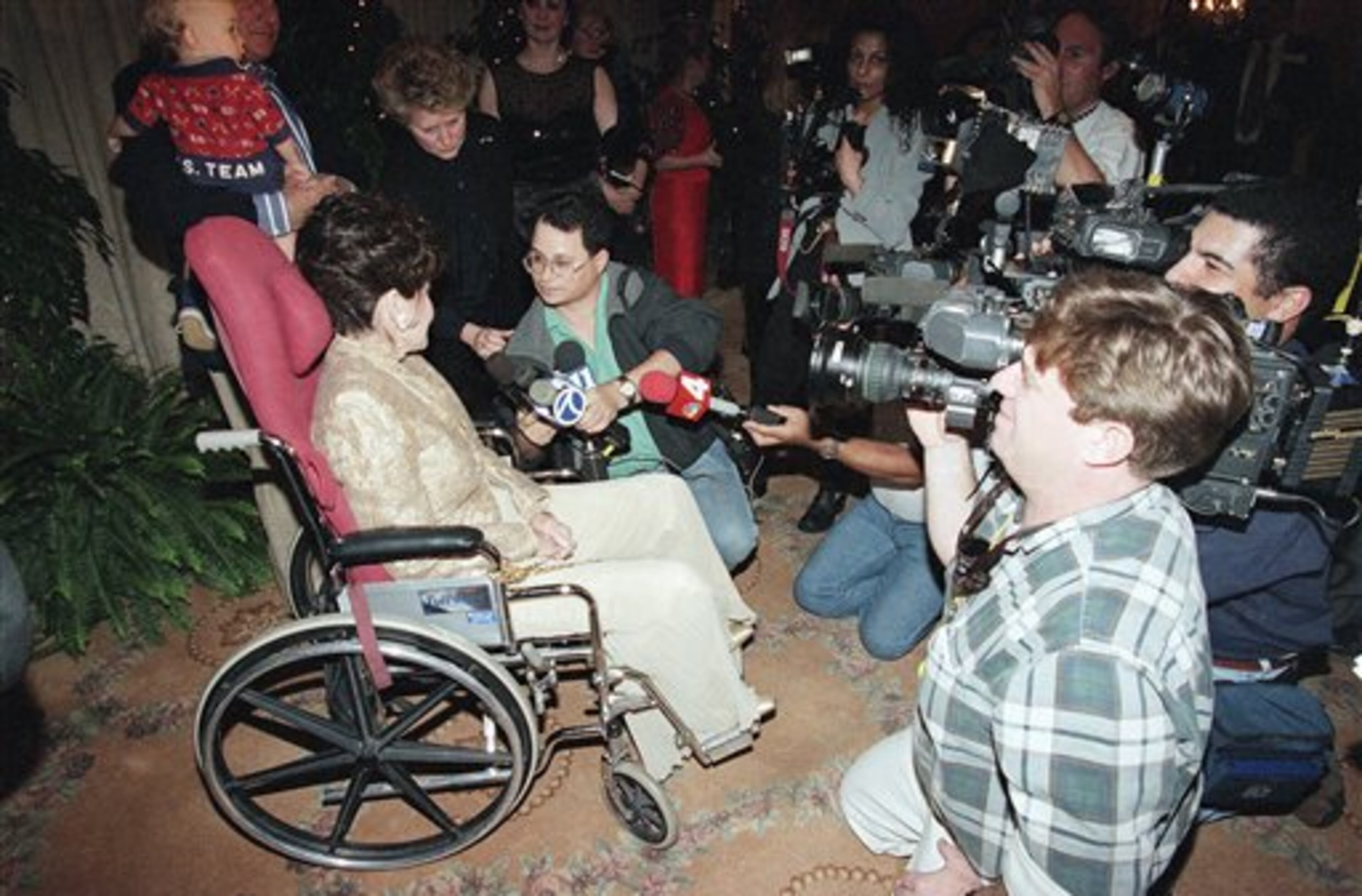 Actress Annette Funicello, left, is besieged by news media during a tribute honoring Funicello at the Regent Beverly Wilshire Hotel in Beverly Hills, Calif., Feb. 15, 1997. The Women in Show Business honored Funicello for her years of bringing smiles to children of all ages. (AP Photo/Michael Caulfield)
