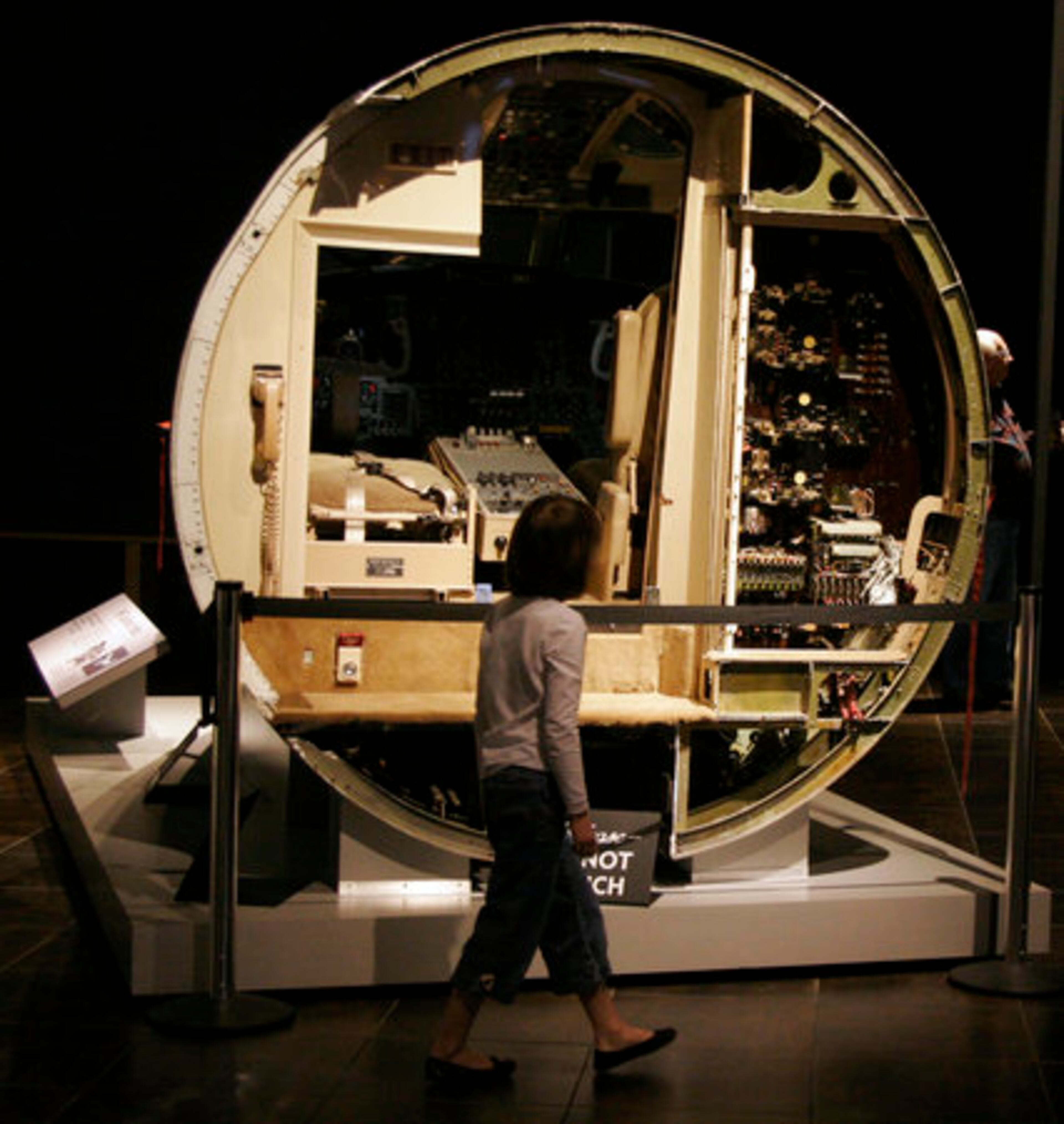 A VISITOR walks past the cockpit of a jet airplane. Tellus has four themes: transportation, minerals, fossils and "My Big Backyard."
