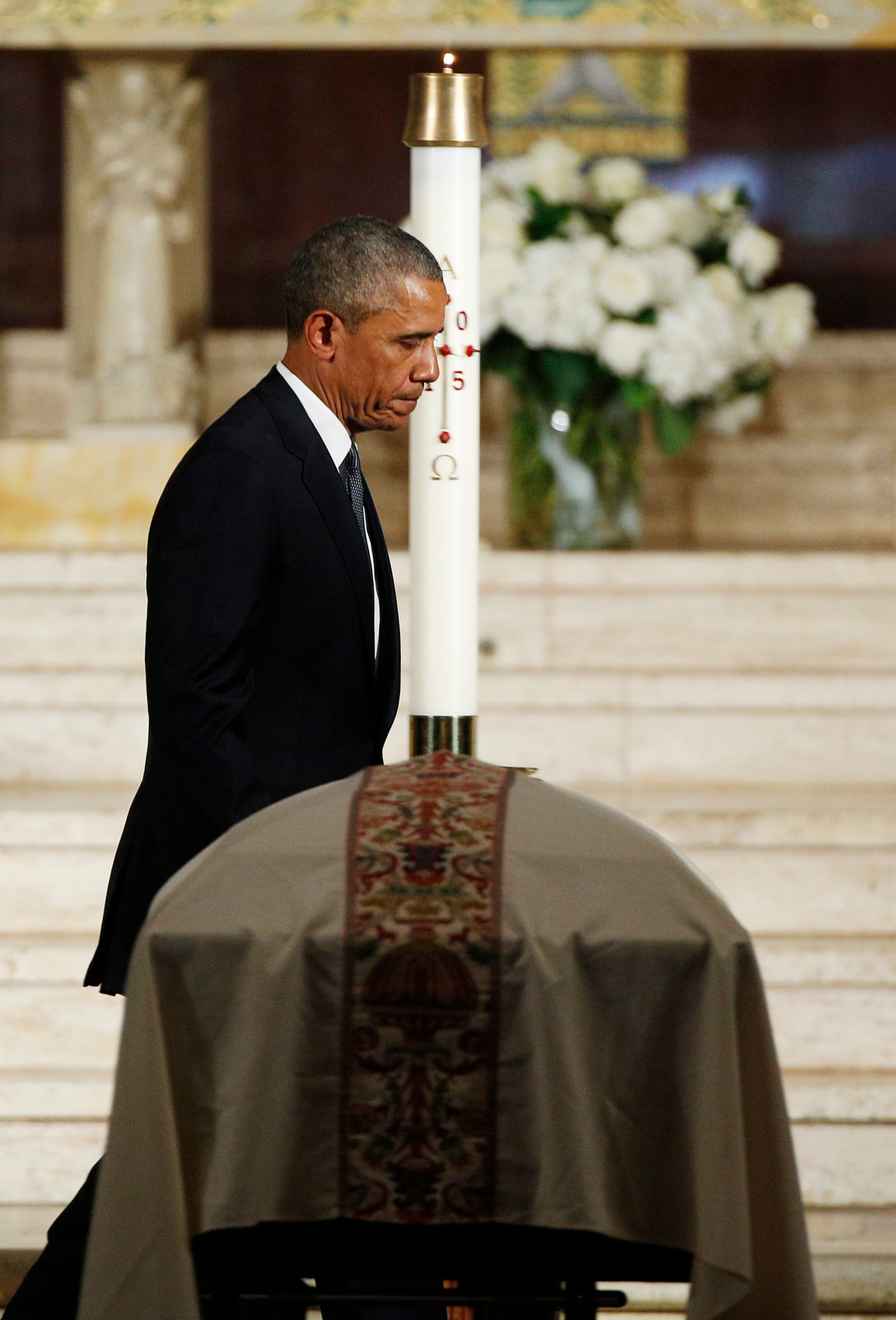 President Barack Obama walks past the casket of Vice President Joe Biden's son, Beau after delivering the eulogy, Saturday, June 6, 2015, at St. Anthony of Padua Church in Wilmington, Del. (Kevin Lamarque/Pool Photo via AP)