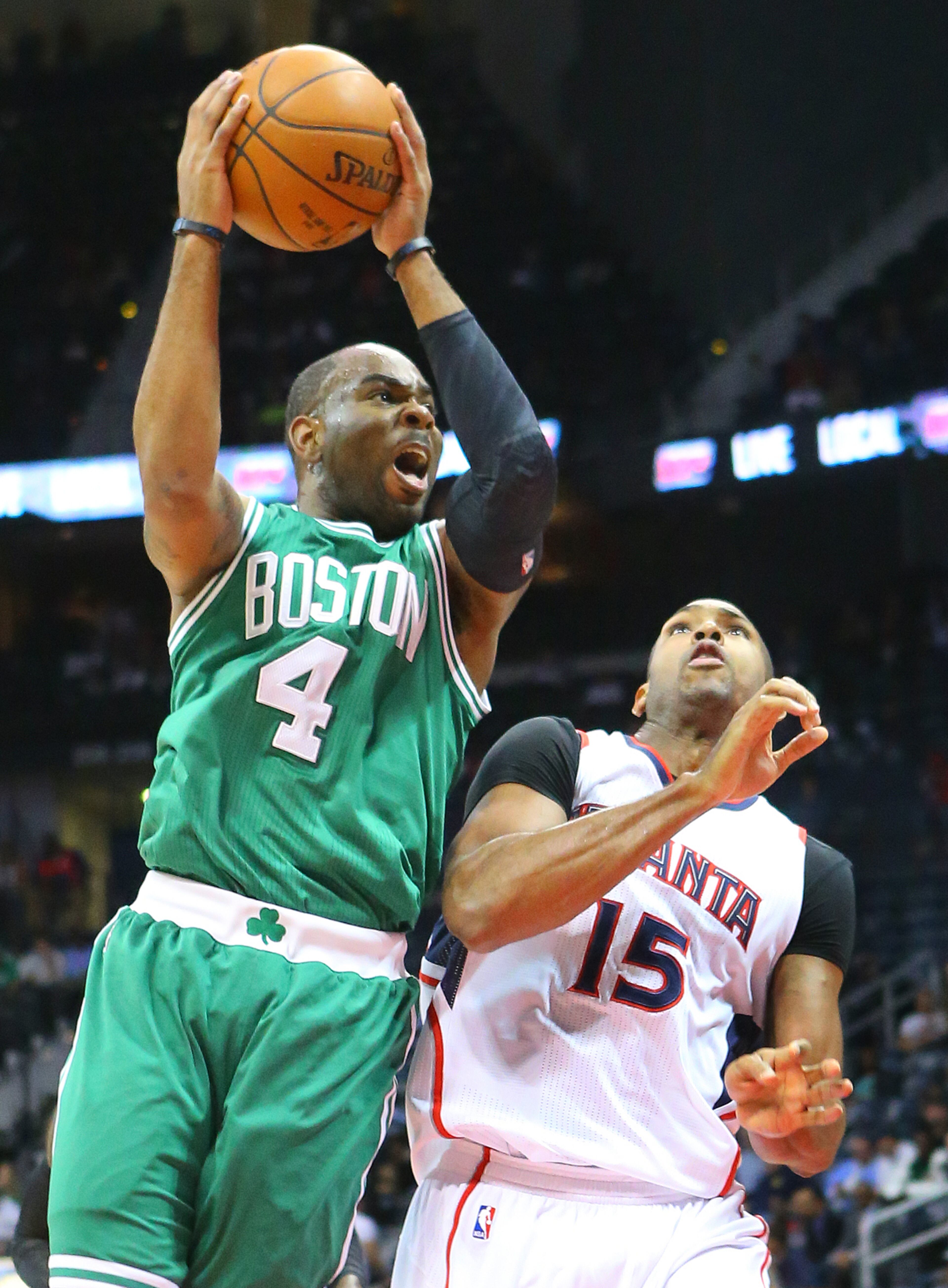 Celtics guard Marcus Thornton collides with Hawks center Al Horford on his way to the basket during the first half in an NBA basketball game on Tuesday, Dec. 2, 2014, in Atlanta. CURTIS COMPTON / CCOMPTON@AJC.COM