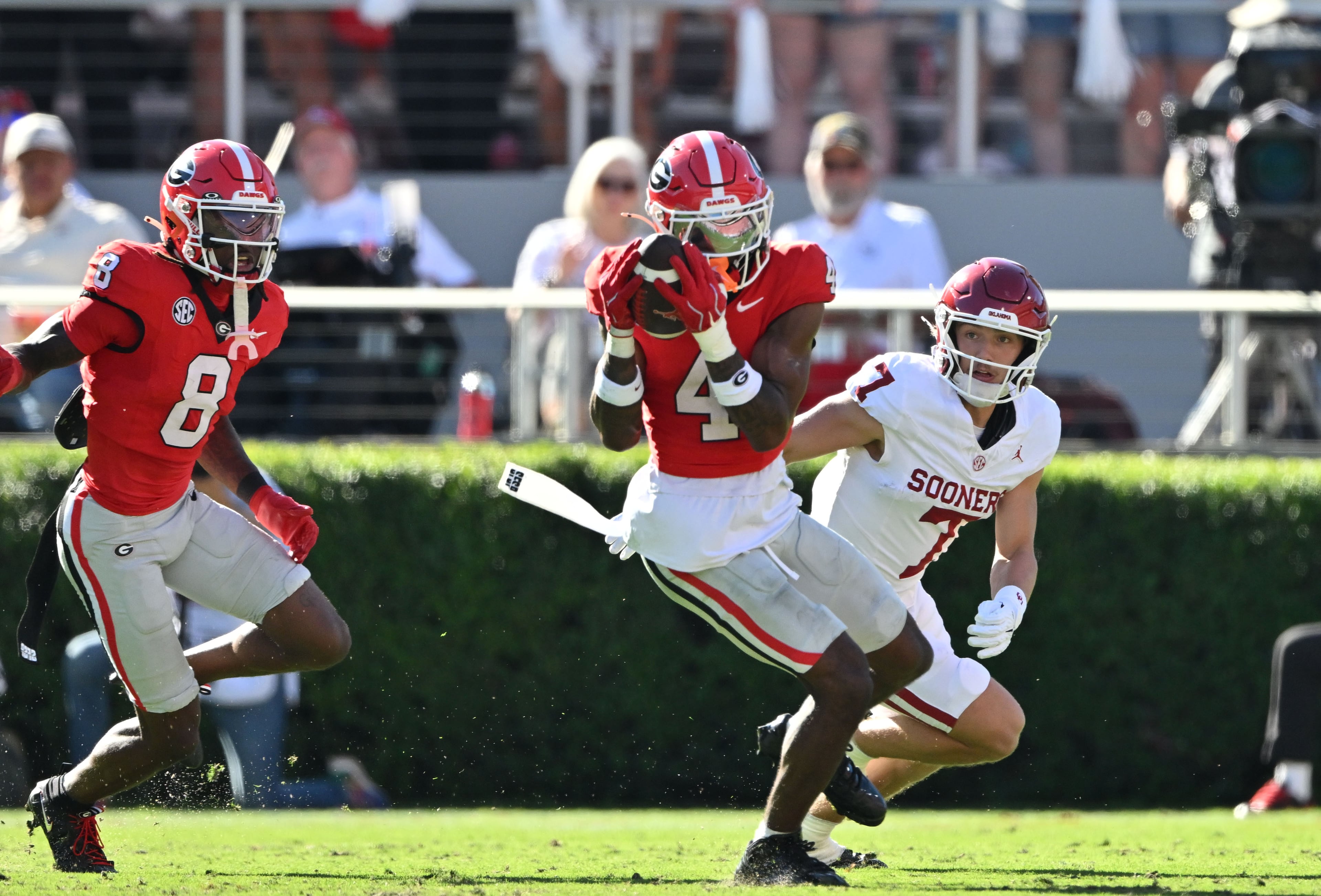 Georgia defensive back KJ Bolden (center) intercepts a pass against Oklahoma and runs it back for a touchdown during the first half in an NCAA football game at Sanford Stadium on Saturday, Sept. 26, 2026, in Athens, Ga. Georgia went on to win 41-13. (Hyosub Shin/AJC)