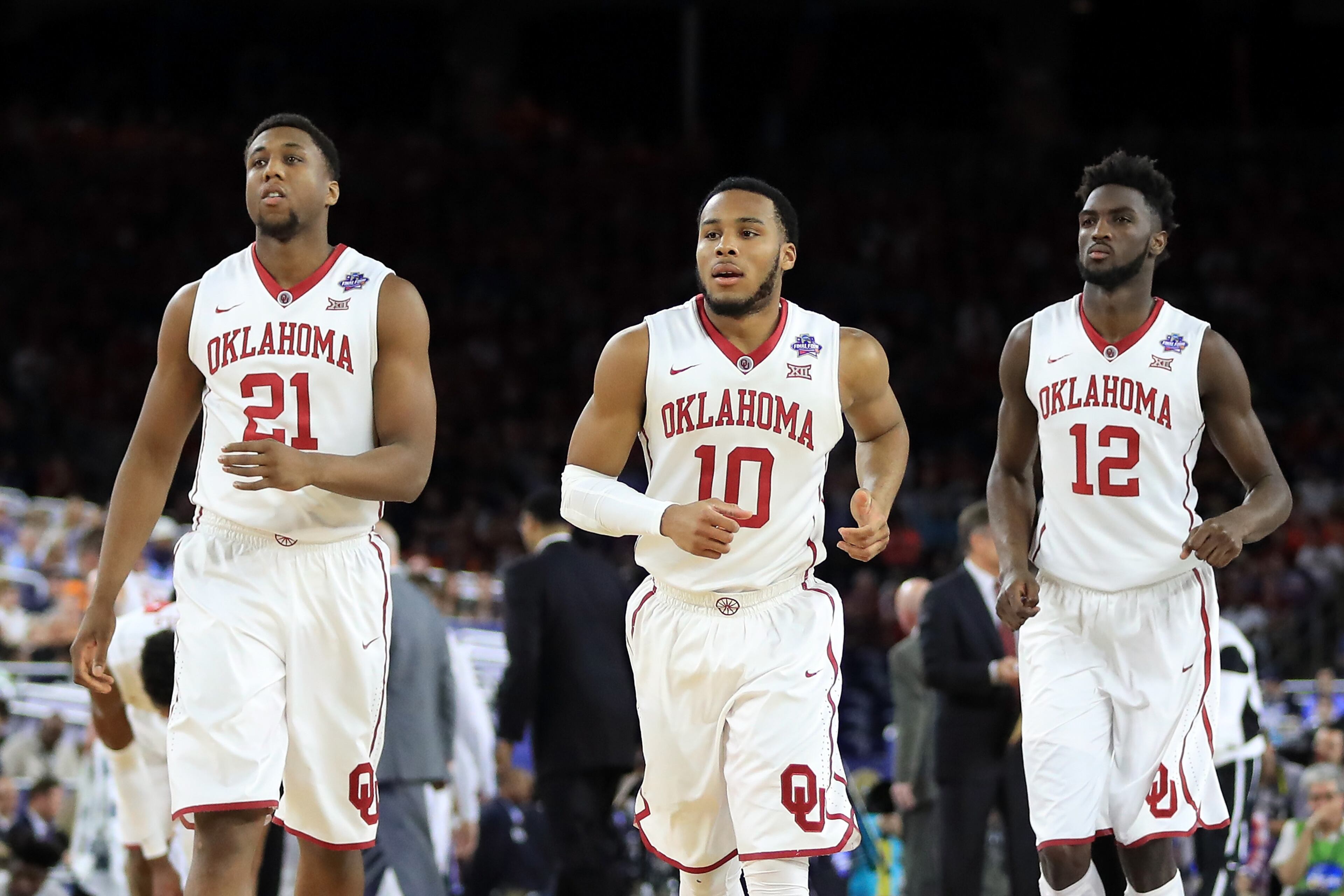 HOUSTON, TEXAS - APRIL 02: (L-R) Dante Buford #21 of the Oklahoma Sooners, Jordan Woodard #10, and Khadeem Lattin #12 react in the first half against the Villanova Wildcats during the NCAA Men's Final Four Semifinal at NRG Stadium on April 2, 2016 in Houston, Texas. (Photo by Ronald Martinez/Getty Images)