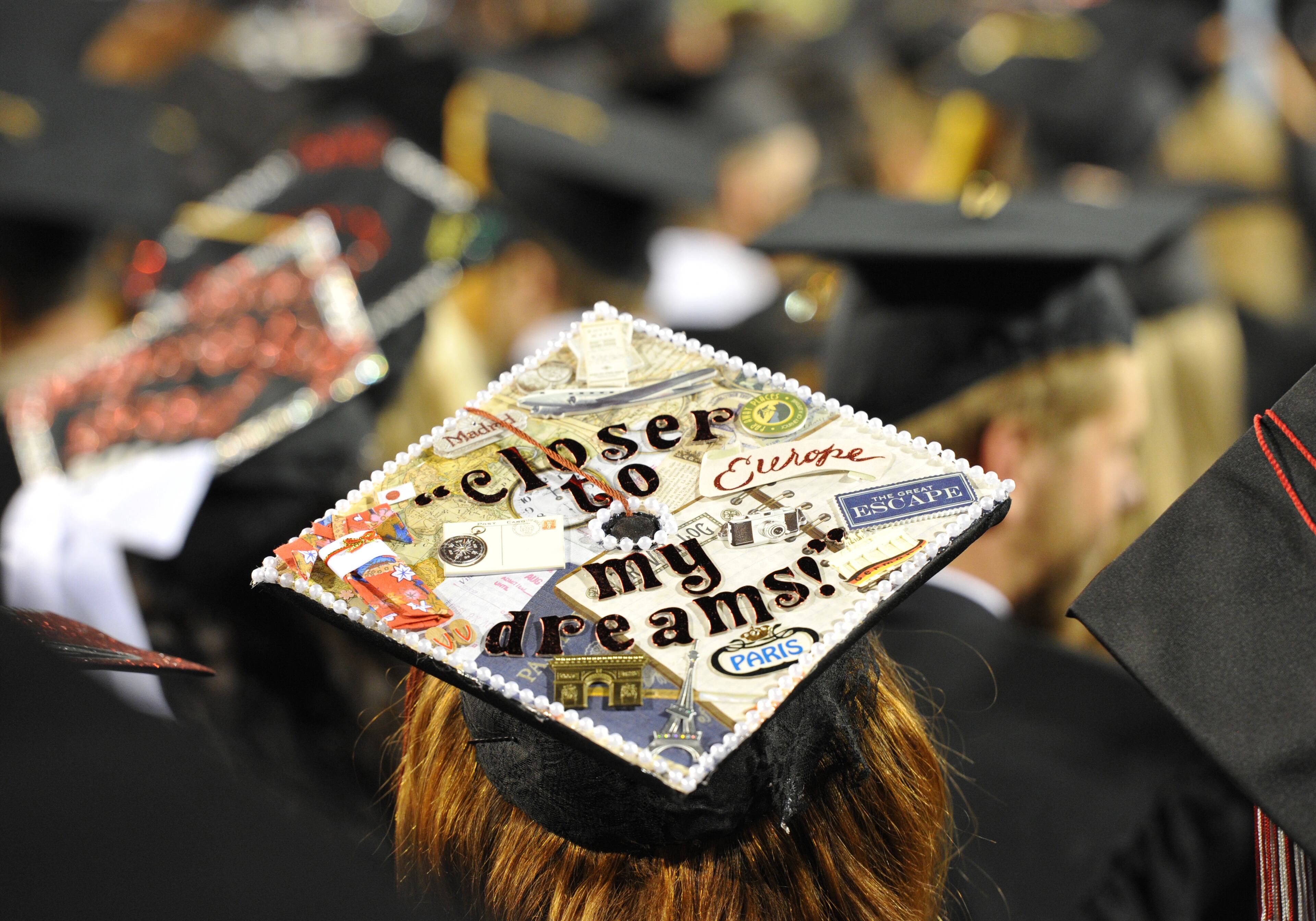 University of Georgia graduates wear decorated mortar boards during the Georgia 2014 Spring undergraduate commencement at Sanford Stadium in Athens on Friday night, May 9, 2014. HYOSUB SHIN / HSHIN@AJC.COM