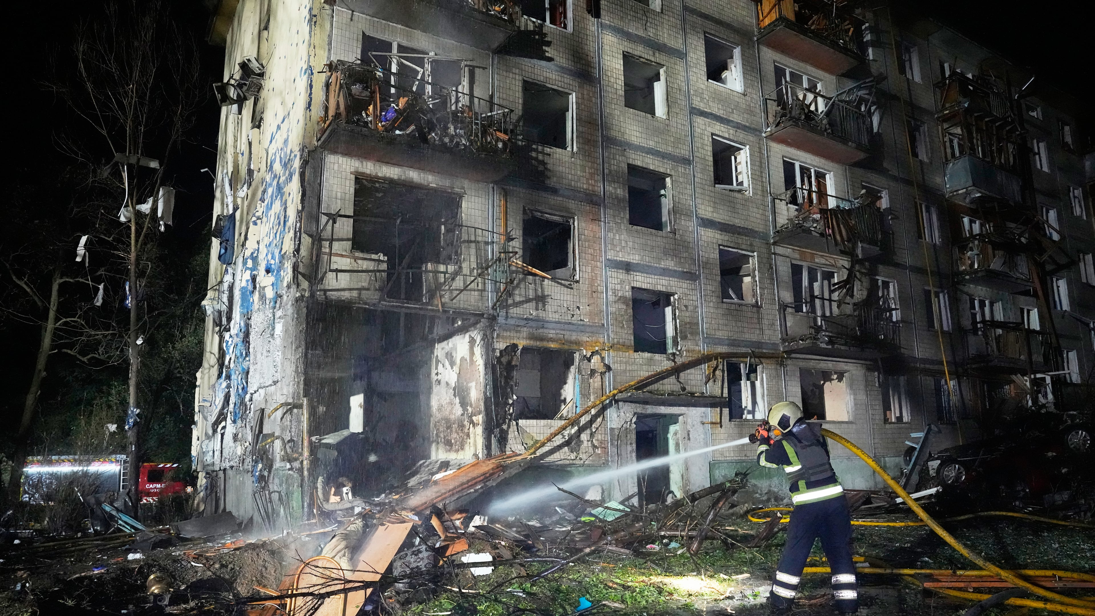 Emergency services personnel work to extinguish a fire following Russian missile attacks in Kyiv, Ukraine, Saturday, Aug. 1, 2026. (AP Photo/Efrem Lukatsky)