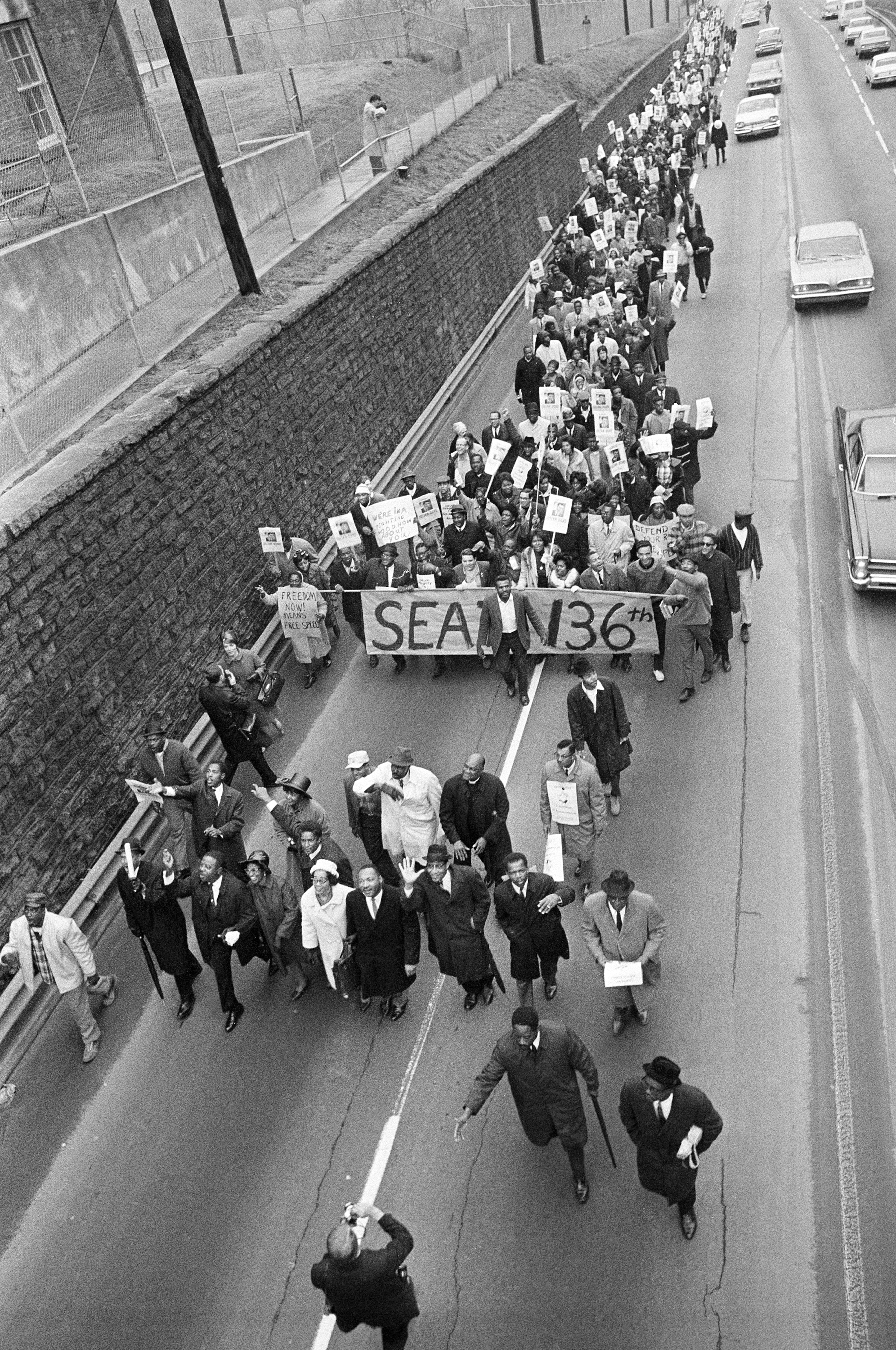 Dr. Martin Luther King Jr., (bottom, 5th from left) leads this long line of demonstrators toward Georgia’s State Capitol in Atlanta, Jan. 14, 1966, in protest of the Georgia House’s barring Rep.-elect Julian Bond. Bond, a 26-year-old civil rights worker, was refused his seat in the House for his statements opposing the draft and denouncing U.S. participation in Viet Nam. (AP Photo/Horace Cort)