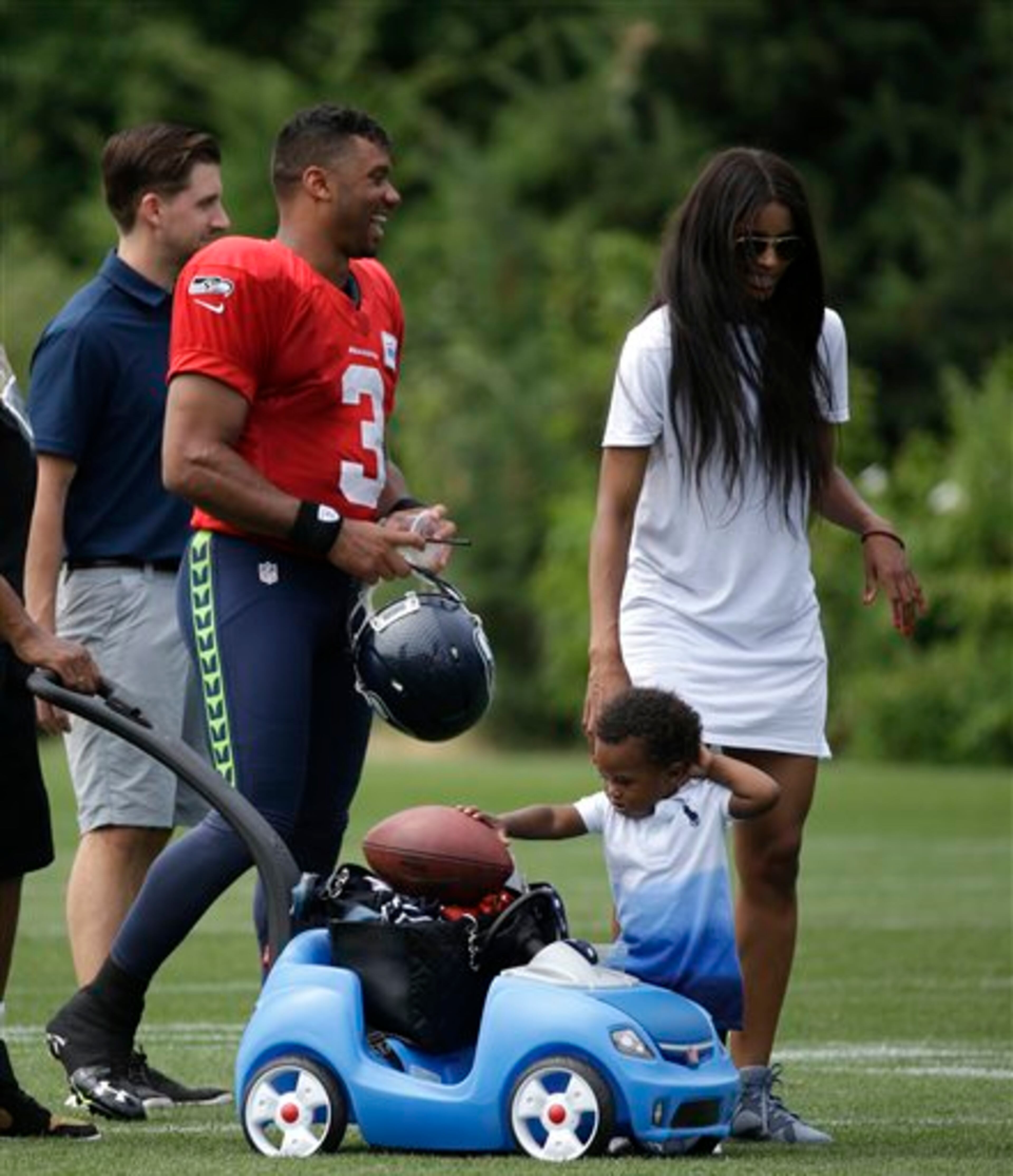 Seattle Seahawks quarterback Russell Wilson, left, stands with his girlfriend, entertainer Ciara Harris, and her son, Future Harris, 14 months, after an NFL football training camp Monday, Aug. 3, 2015, in Renton, Wash. (AP Photo/Elaine Thompson)