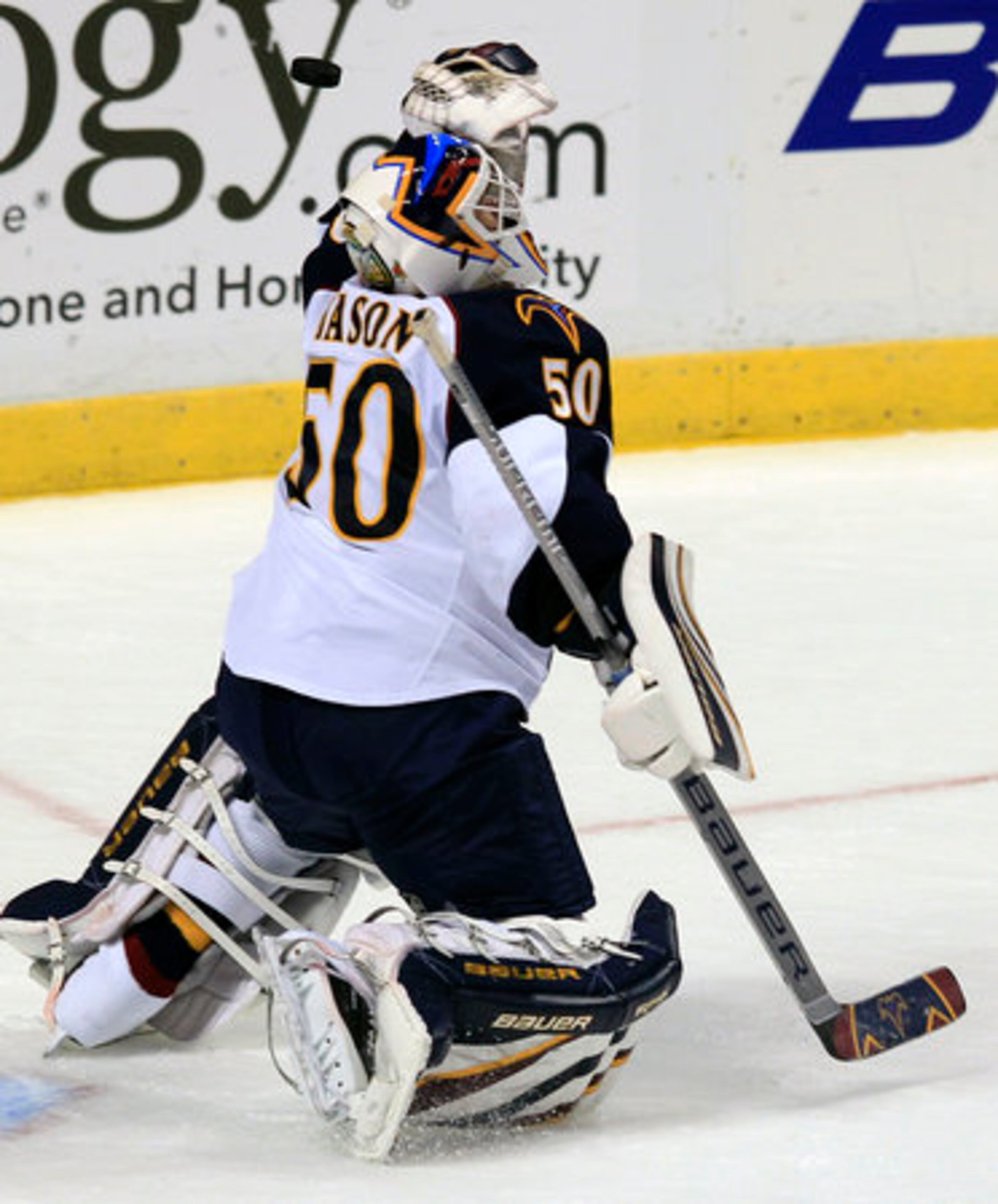 Atlanta Thrashers goalie Chris Mason bats a puck hit by the Florida Panthers during the first period of an NHL hockey game in Sunrise, Fla., Wednesday, Nov. 3, 2010.