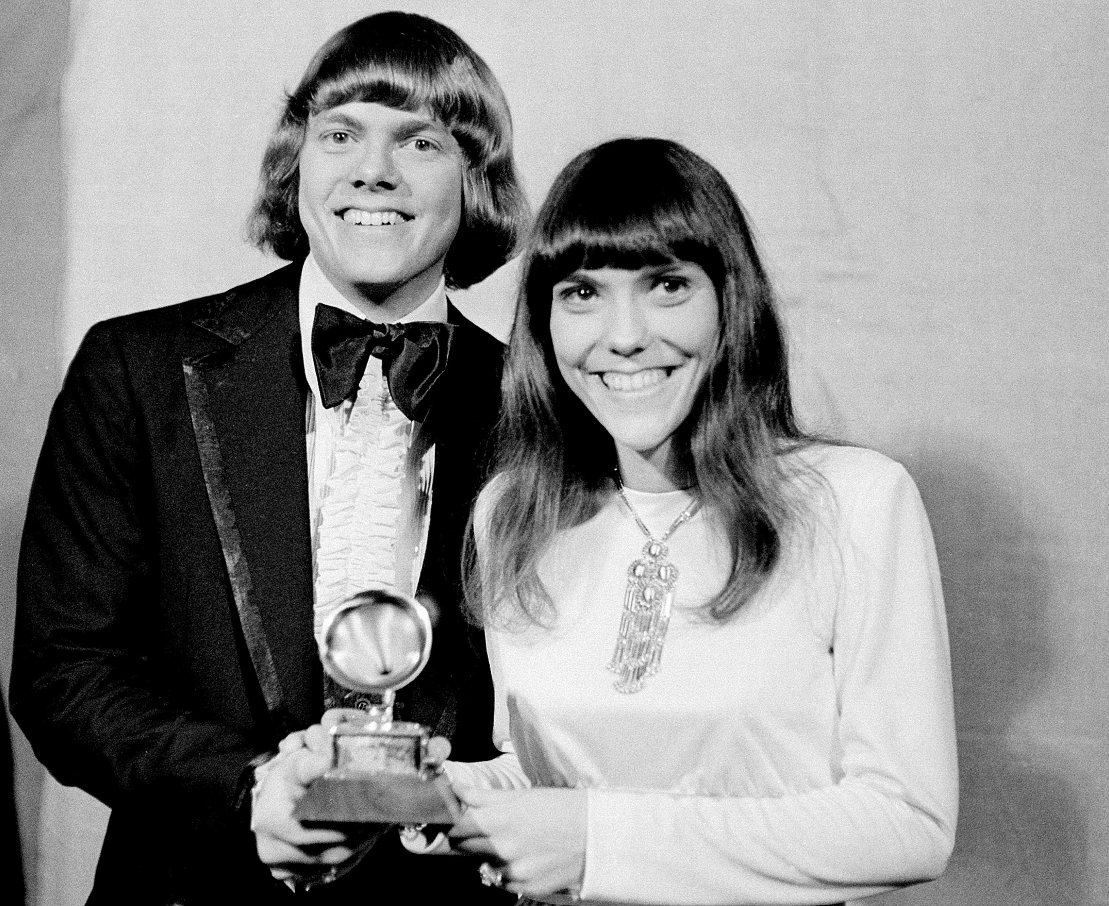 In this March 17, 1971 file photo, Richard and Karen Carpenter of The Carpenters pose with their Grammy during the 13th annual 1970 Grammy Awards in Los Angeles. The brother-sister duo was named best new artist of the year, 1970, and also won as the best contemporary duo or group vocalists for "Close to You." In a new collection “Carpenters with the Royal Philharmonic Orchestra,” Richard Carpenter gave new string arrangements to many of the duo’s classic recordings from the late 1960s through the early 1980s, including “Close to You” and “Superstar." (AP Photo, File)