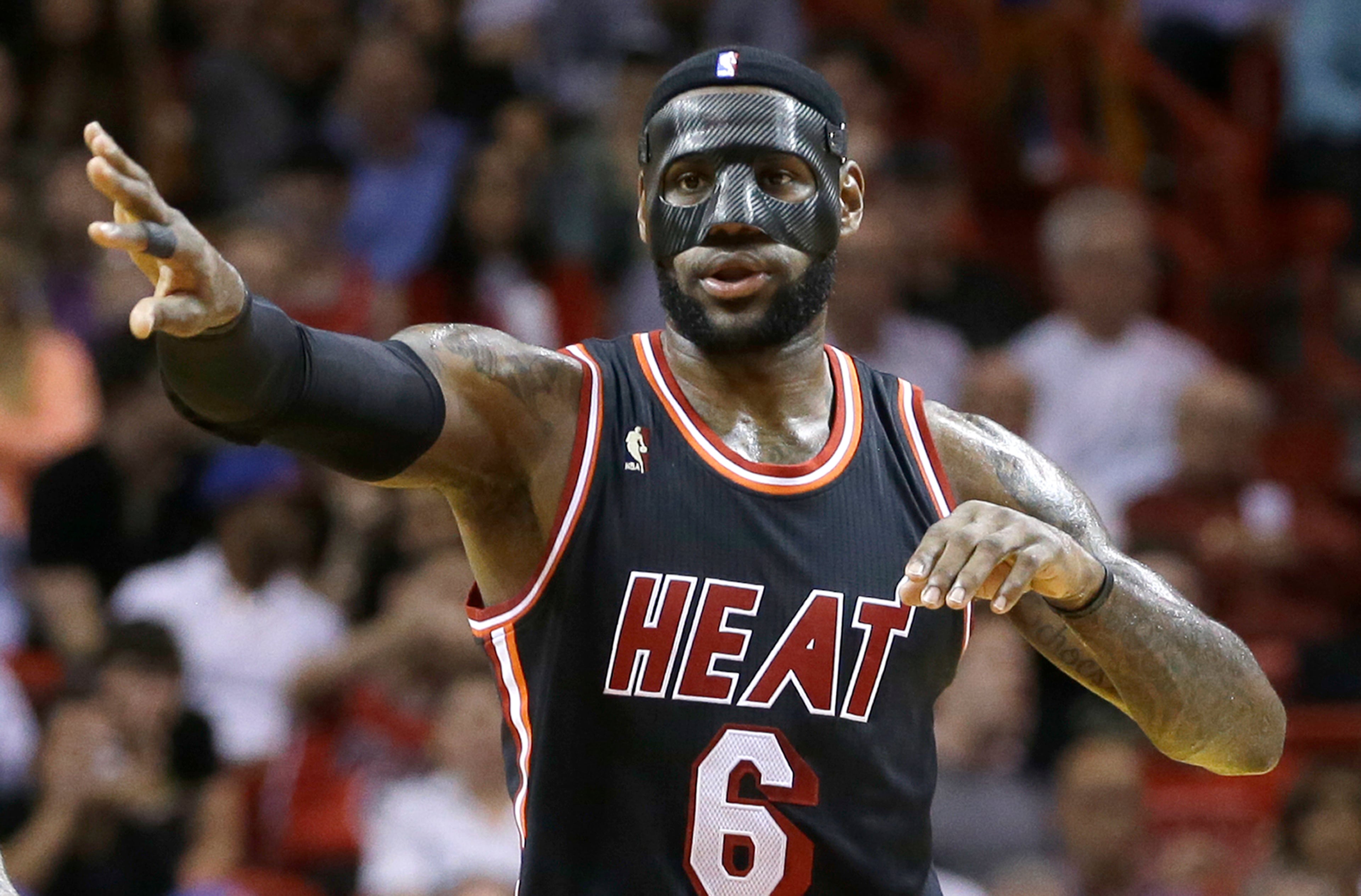 LeBron James dispensed with his menacing black mask at the NBA's request and switched to a clear protective cover for the Miami Heat's game Saturday against the Orlando Magic. The black mask made its debut Thursday in James' first game since he broke his nose. He said he received word from league officials Friday that they wanted him to instead wear something that would allow opponents to see his face.