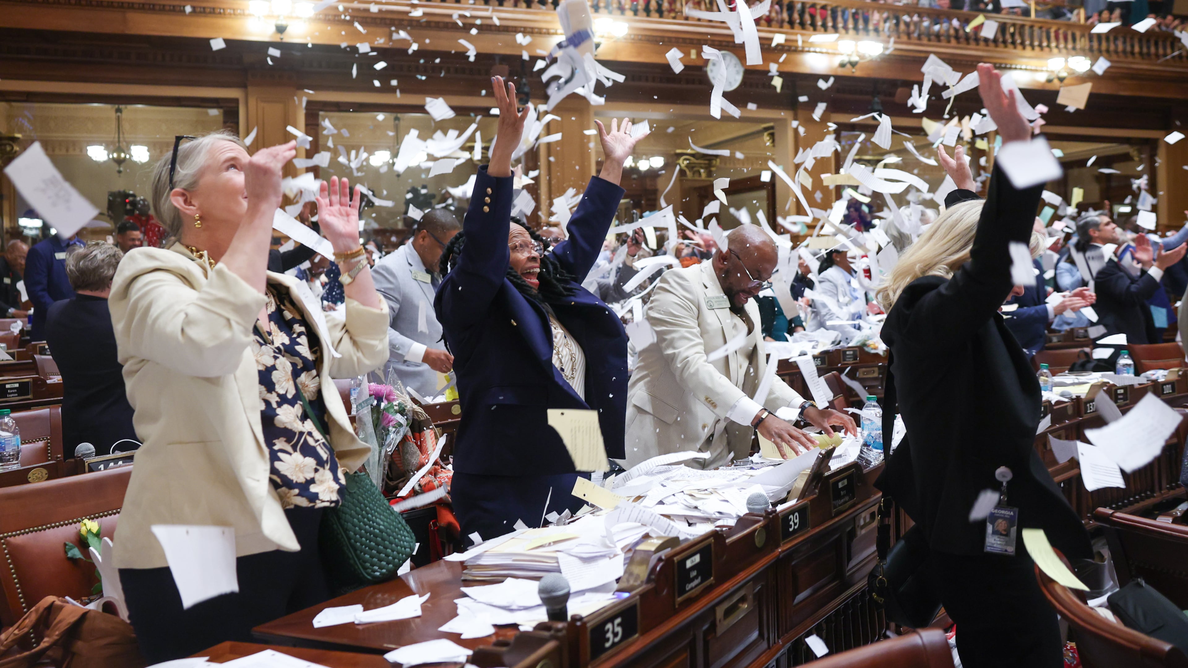 Representatives toss papers when session is called to a close at the House of Representatives on Sine Die, the last day of the legislative session, at the Capitol in Atlanta on April 2, 2026. (Arvin Temkar/AJC)