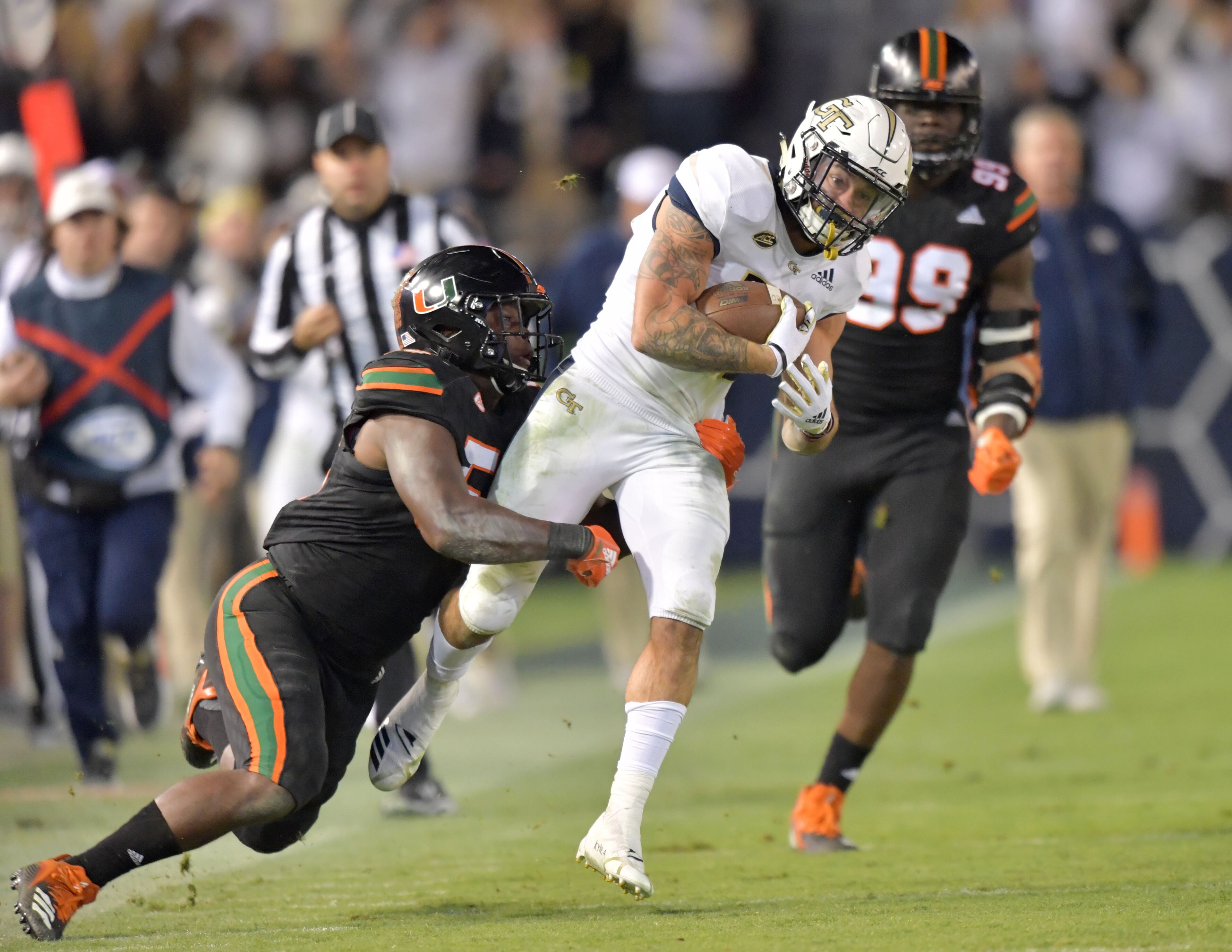 November 10, 2018 Atlanta - Georgia Tech running back Nathan Cottrell (31) gets tackled by DUPLICATE***Miami offensive lineman Navaughn Donaldson (55)***Miami linebacker Shaquille Quarterman (55) in the second half at Bobby Dodd Stadium on Saturday, November 10, 2018. Georgia Tech won 27 - 21 over the Miami. HYOSUB SHIN / HSHIN@AJC.COM