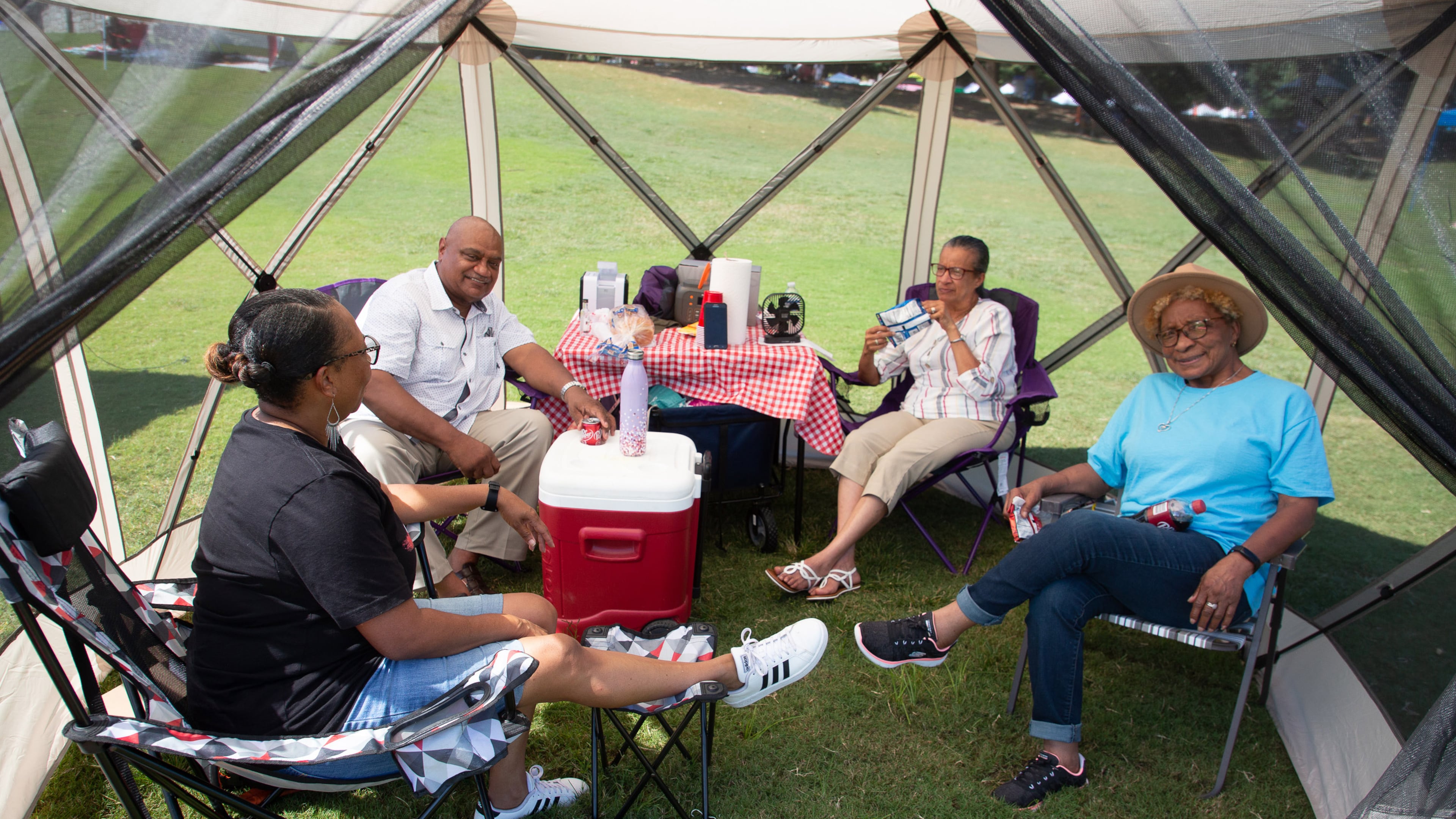The Thompson and Hollis families hang out in their tent, ready for a night full of music during the Atlanta Jazz Festival in Piedmont Park on Sunday, September 5, 2021. STEVE SCHAEFER FOR THE ATLANTA JOURNAL-CONSTITUTION