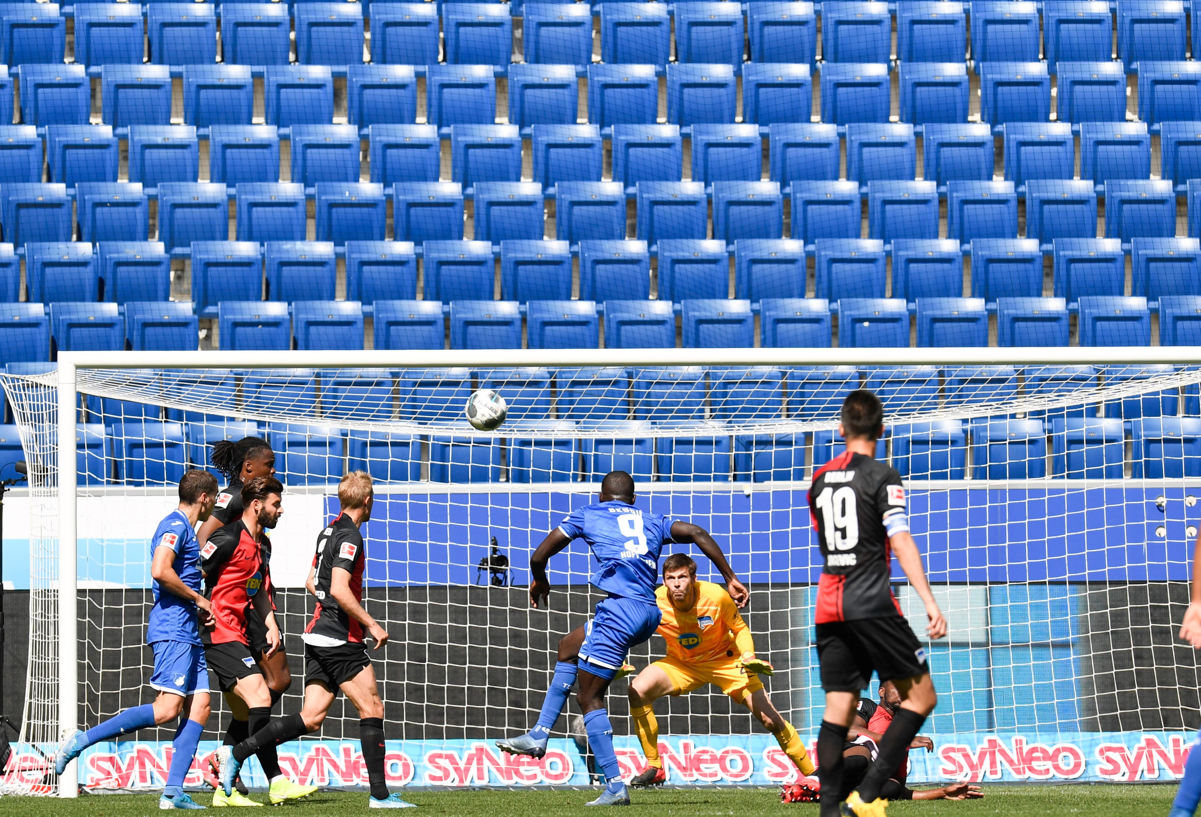 Hoffenheim's Togolese forward Ihlas Bebou, center, fails to score past Hertha's Norwegian goalkeeper Rune Jarstein during the Bundesliga soccer match between TSG 1899 Hoffenheim and Hertha BSC Berlin in Sinsheim, Germany, Saturday, May 16, 2020. The German Bundesliga becomes the world's first major soccer league to resume after a two-month suspension because of the coronavirus pandemic. (Thomas Kienzle/AFP pool via AP)