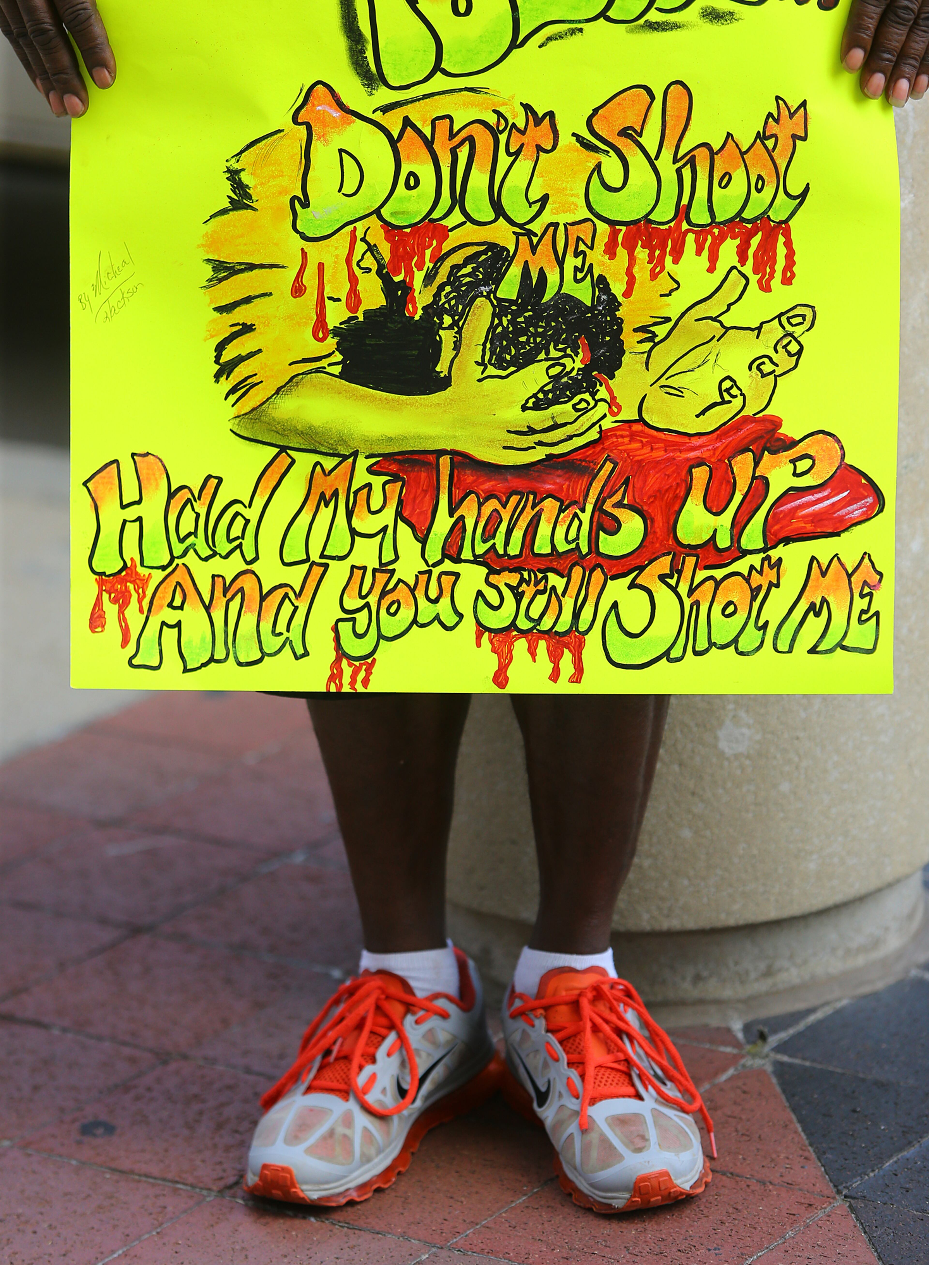 081814 Atlanta: Michael Jackson holds a sign he made during a rally for Mike Brown and Ferguson outside the CNN Center on Monday, August 18, 2014, in Atlanta. CURTIS COMPTON / CCOMPTON@AJC.COM