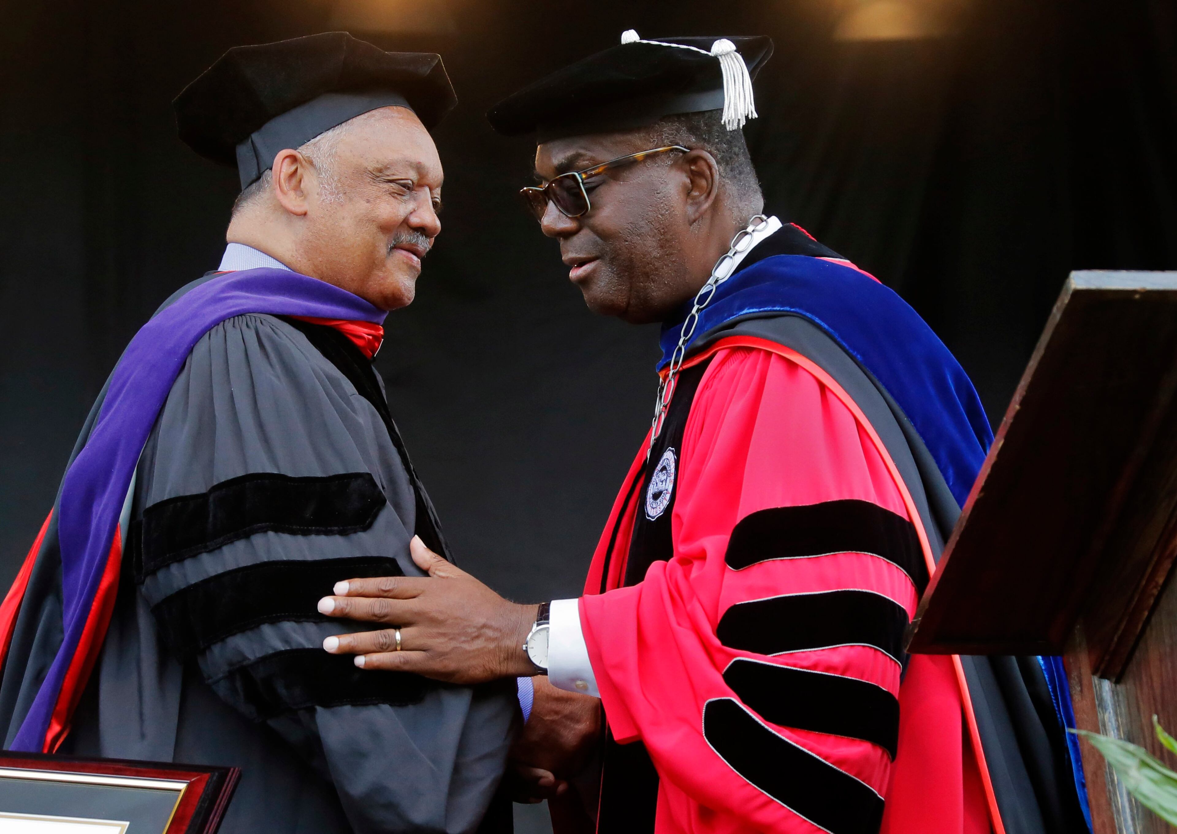 5/22/17 - Atlanta - Rev. Jesse Jackson, is congratulated by President Ronald Johnson after he received an honorary degree. He also spoke. Clark Atlanta University's Panther Stadium was the site of their 28th annual Commencement. Businessman William Pickard gave the commencement address. Panther Stadium, BOB ANDRES /BANDRES@AJC.COM