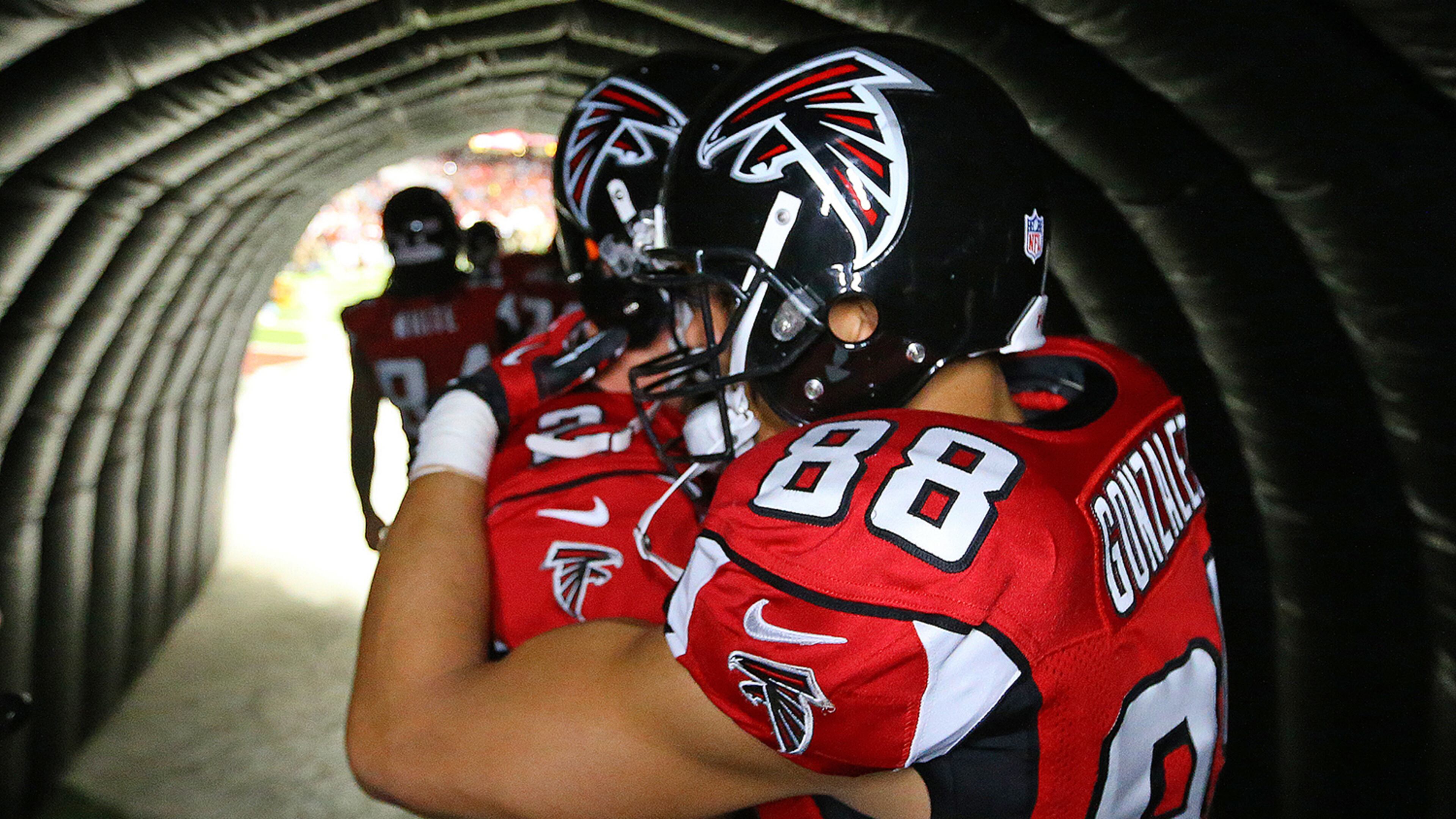122913 ATLANTA: Falcons quarterback Matt Ryan hugs tight end Tony Gonzalez in the tunnel moments before he takes the field for the final game of his 17-year NFL career on Sunday, Dec. 29, 2013, in Atlanta. CURTIS COMPTON / CCOMPTON@AJC.COM