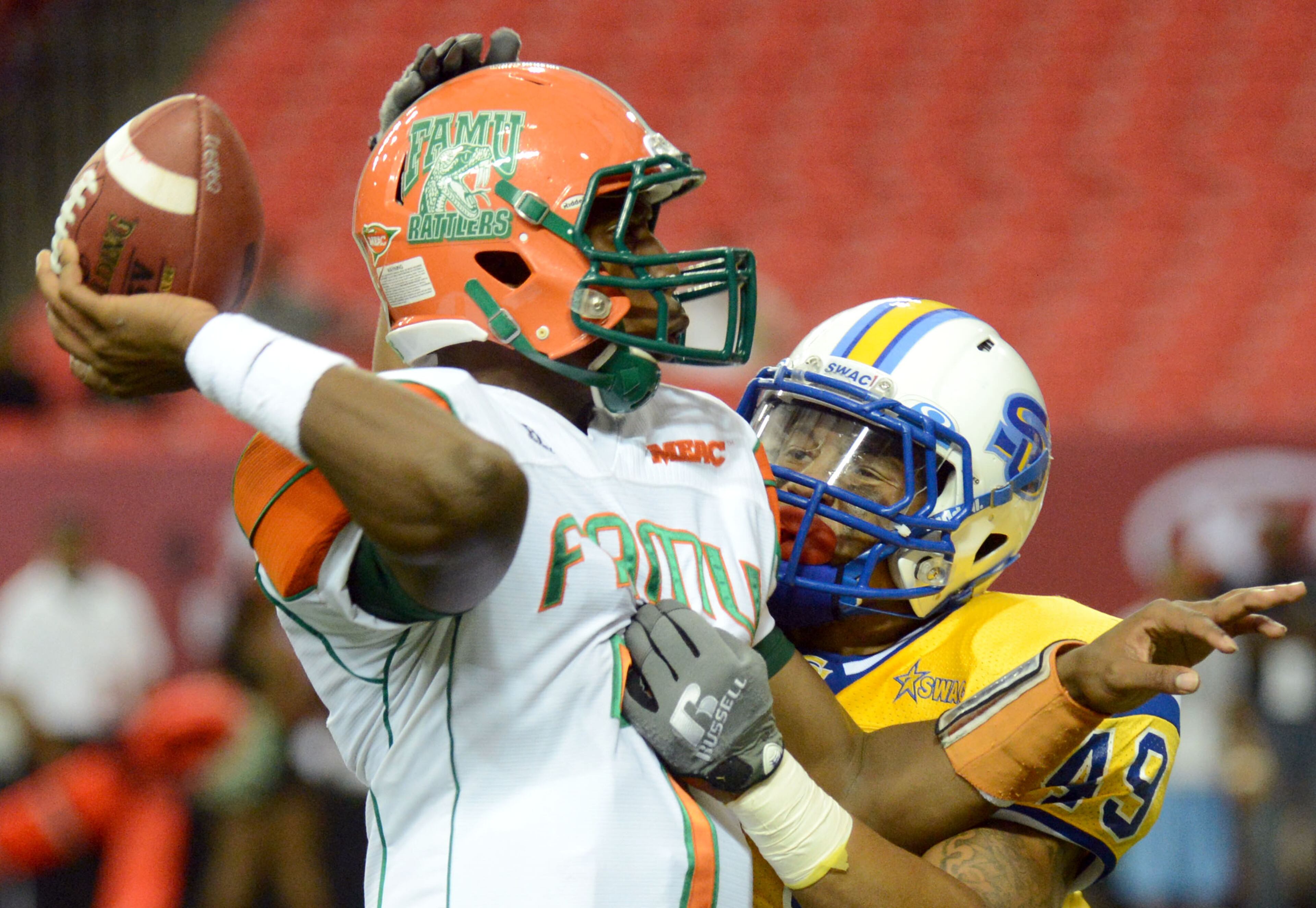 Florida A&M quarterback Damien Fleming (7) launches a touchdown pass as Southern linebacker Anthony Balancier (49) blocks in the first half during the 2012 Bank of America Atlanta Football Classic at the Georgia Dome on Saturday, September 29, 2012.