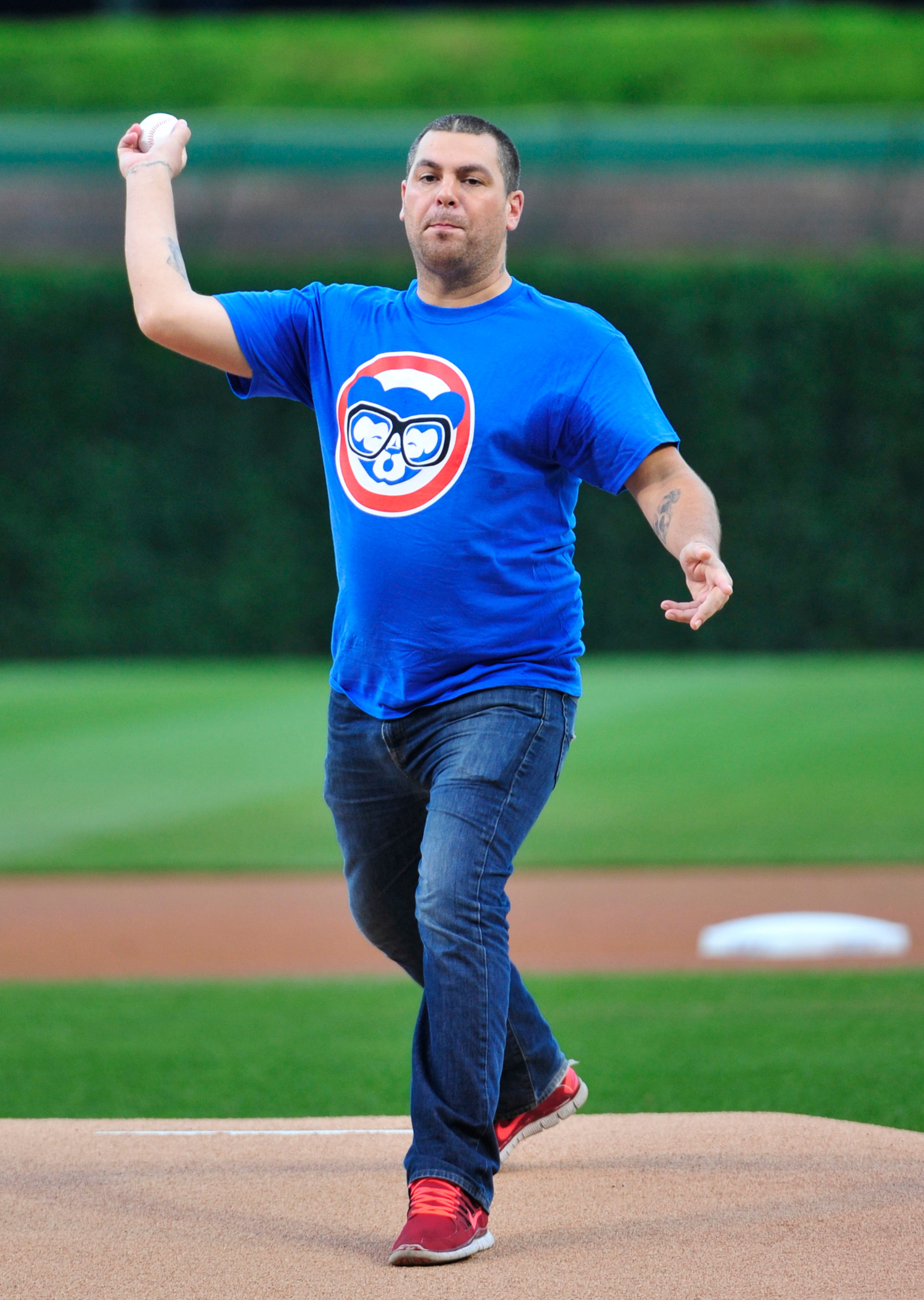 Lead singer of Alien Ant Farm Dryden Mitchell throws out the ceremonial first pitch before a baseball game between the Chicago Cubs and the St. Louis Cardinals, Monday, July 6, 2015, in Chicago. (AP Photo/David Banks)
