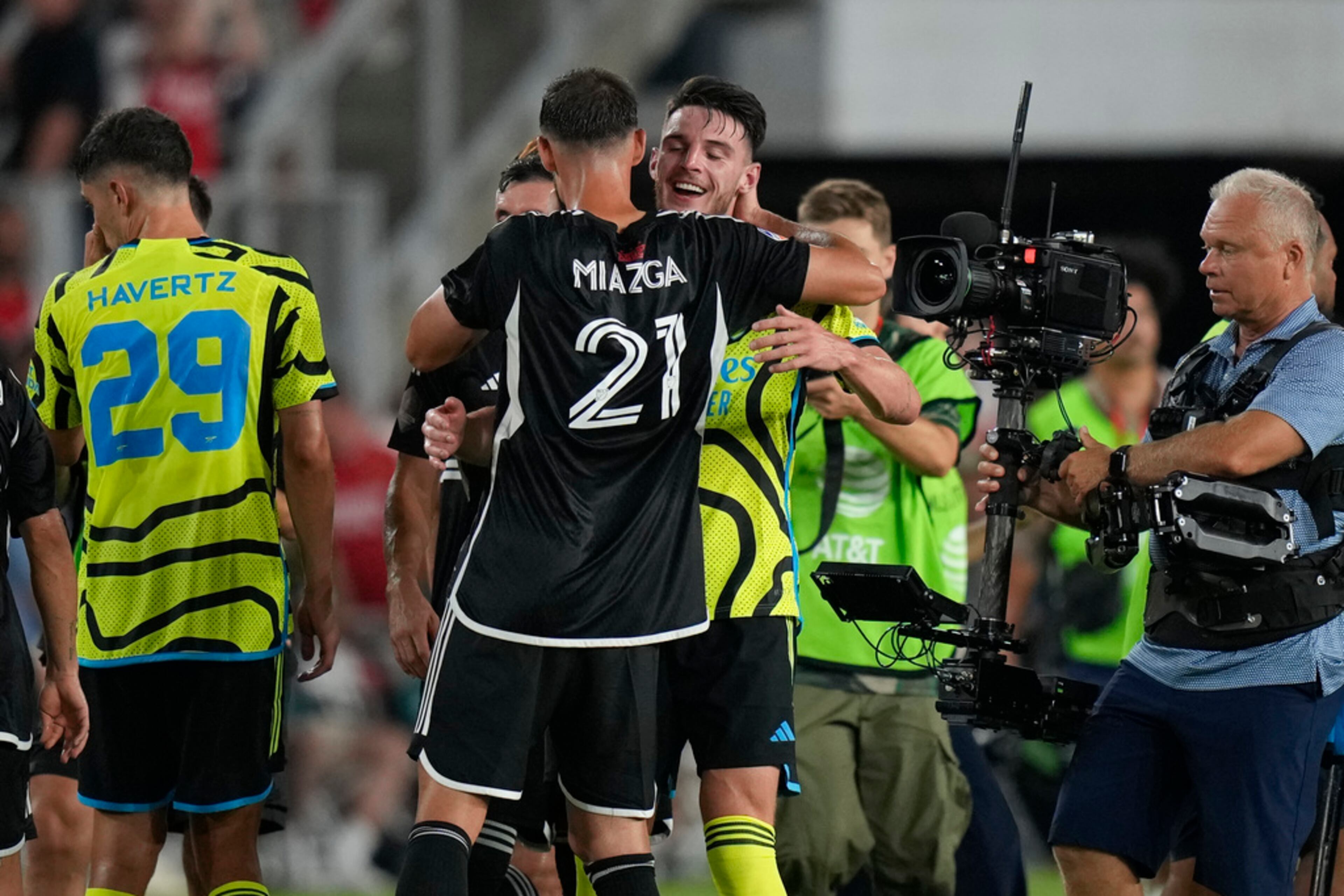 FC Cincinnati defender Matt Miazga (21) hugs Arsenal midfielder Declan Rice after the MLS All-Star soccer match, Wednesday, July 19, 2023, in Washington. Arsenal won 5-0. (AP Photo/Alex Brandon)