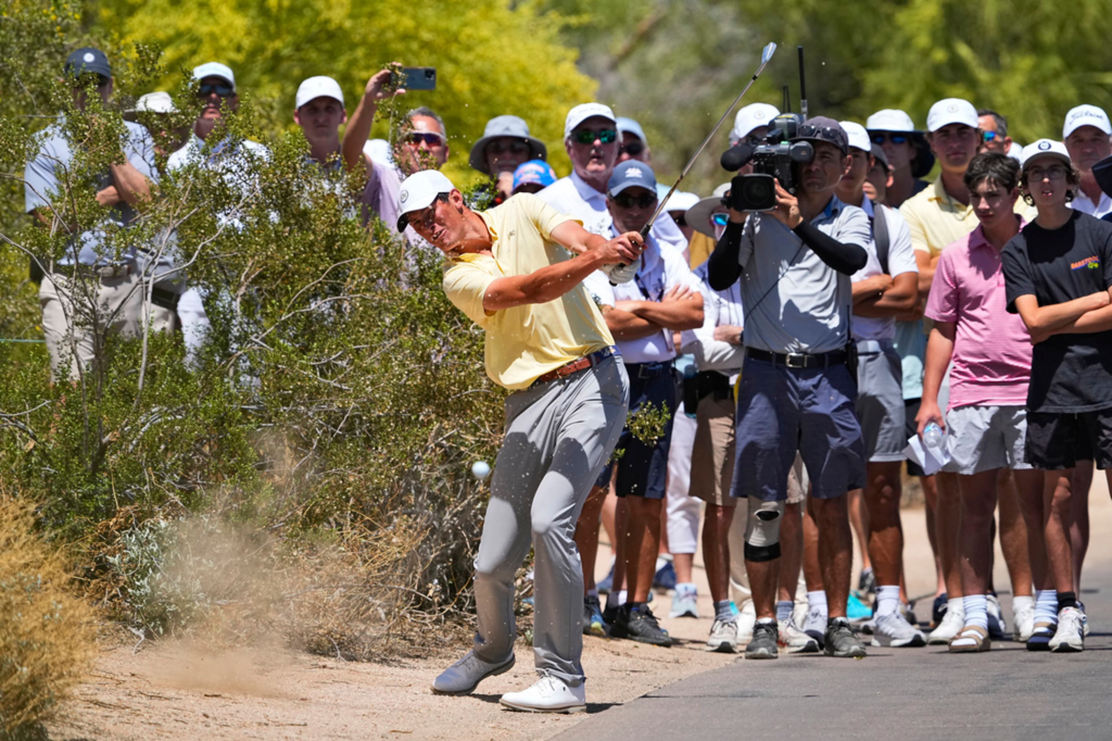 Georgia Tech golfer Christo Lamprecht hits from along the cart path on the first fairway during the final round of the NCAA college men's match play golf championship, Wednesday, May 31, 2023, in Scottsdale, Ariz. (AP Photo/Matt York)