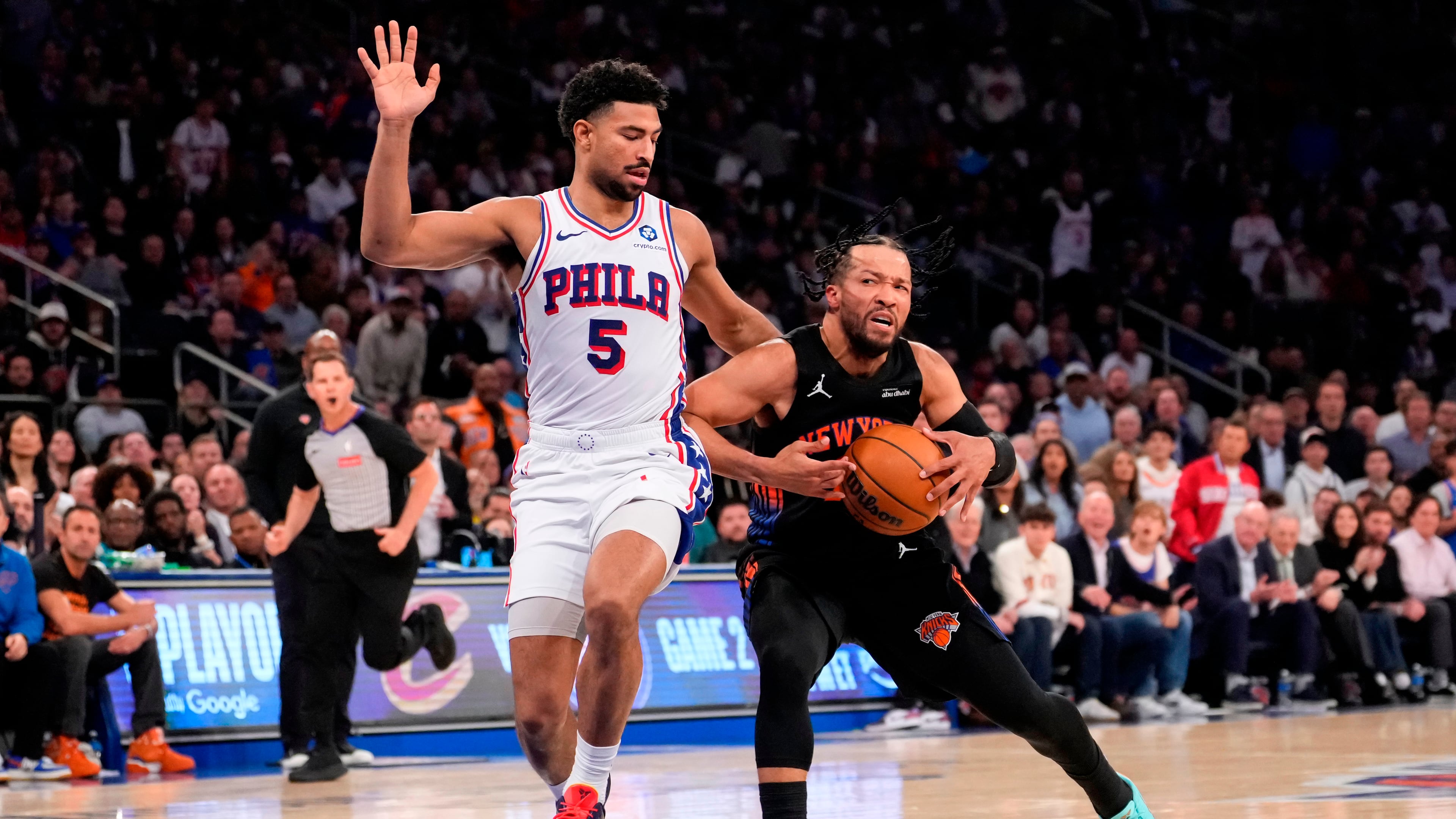 New York Knicks guard Jalen Brunson, right, drives past Philadelphia 76ers guard Quentin Grimes (5) during the first half of Game 2 in a second-round NBA basketball playoffs series, Wednesday, May 6, 2026, in New York. (AP Photo/Yuki Iwamura)