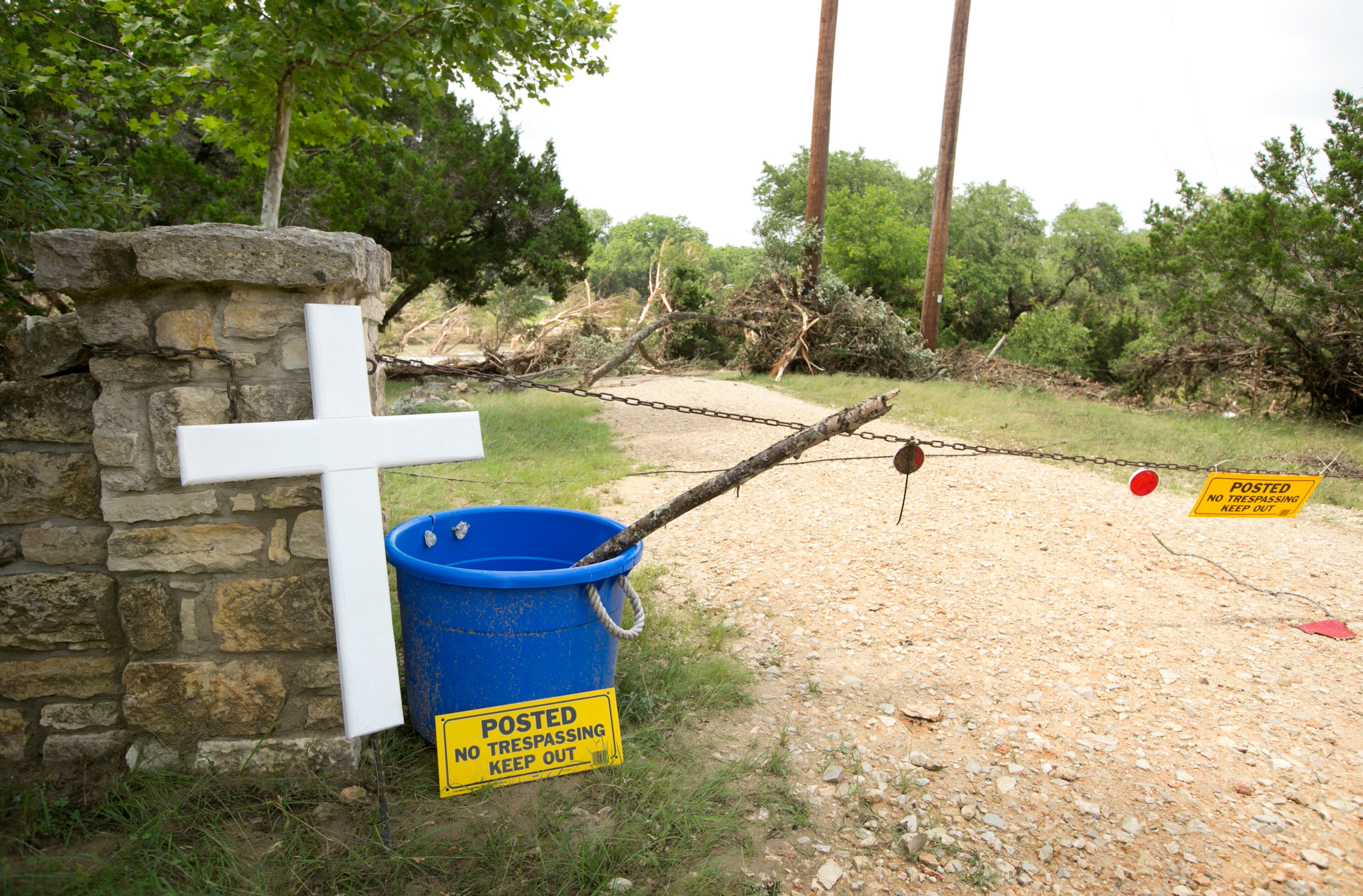 A cross marks the spot of the remains of a vacation home in Wimberley on Thursday May 28, 2015, where eight people from Corpus Christi were swept away in the flood.