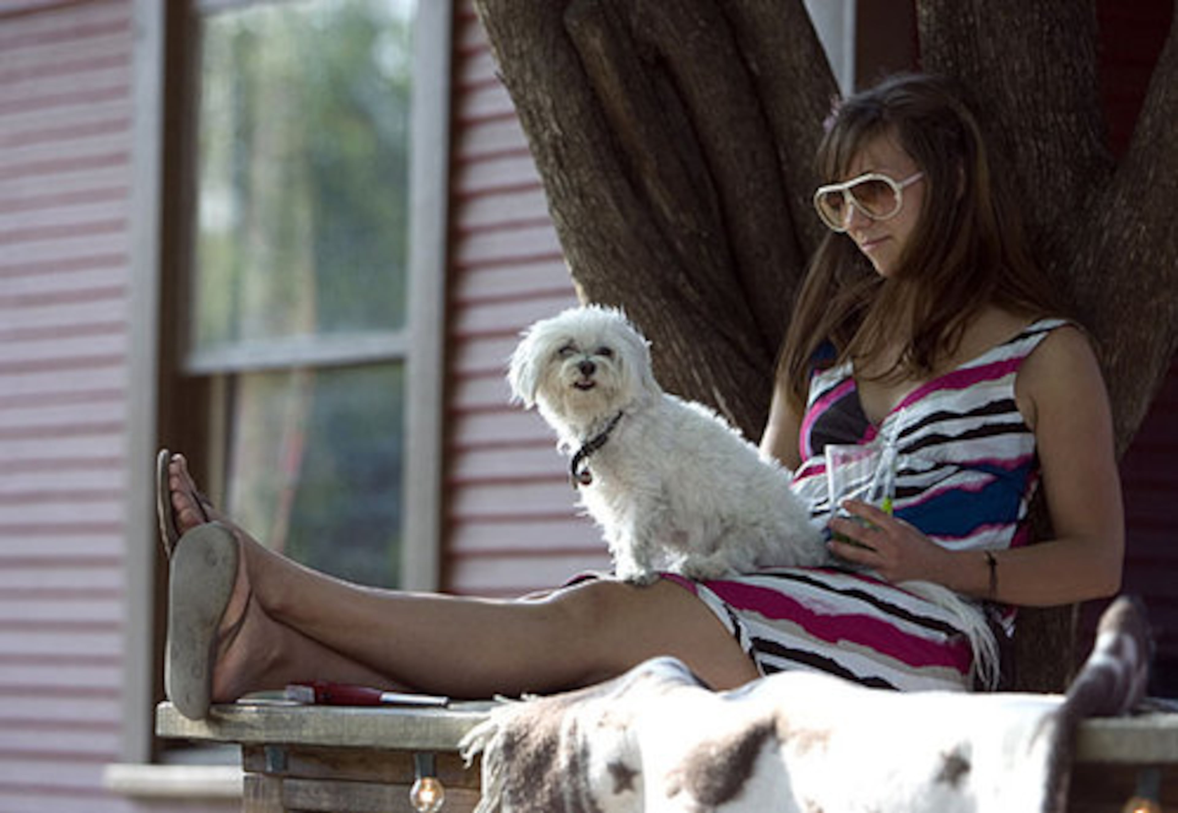Jennifer Hughes and her dog Fernando find a comfortable spot to listen to music at a party at Red House Pizzeria during SXSW.