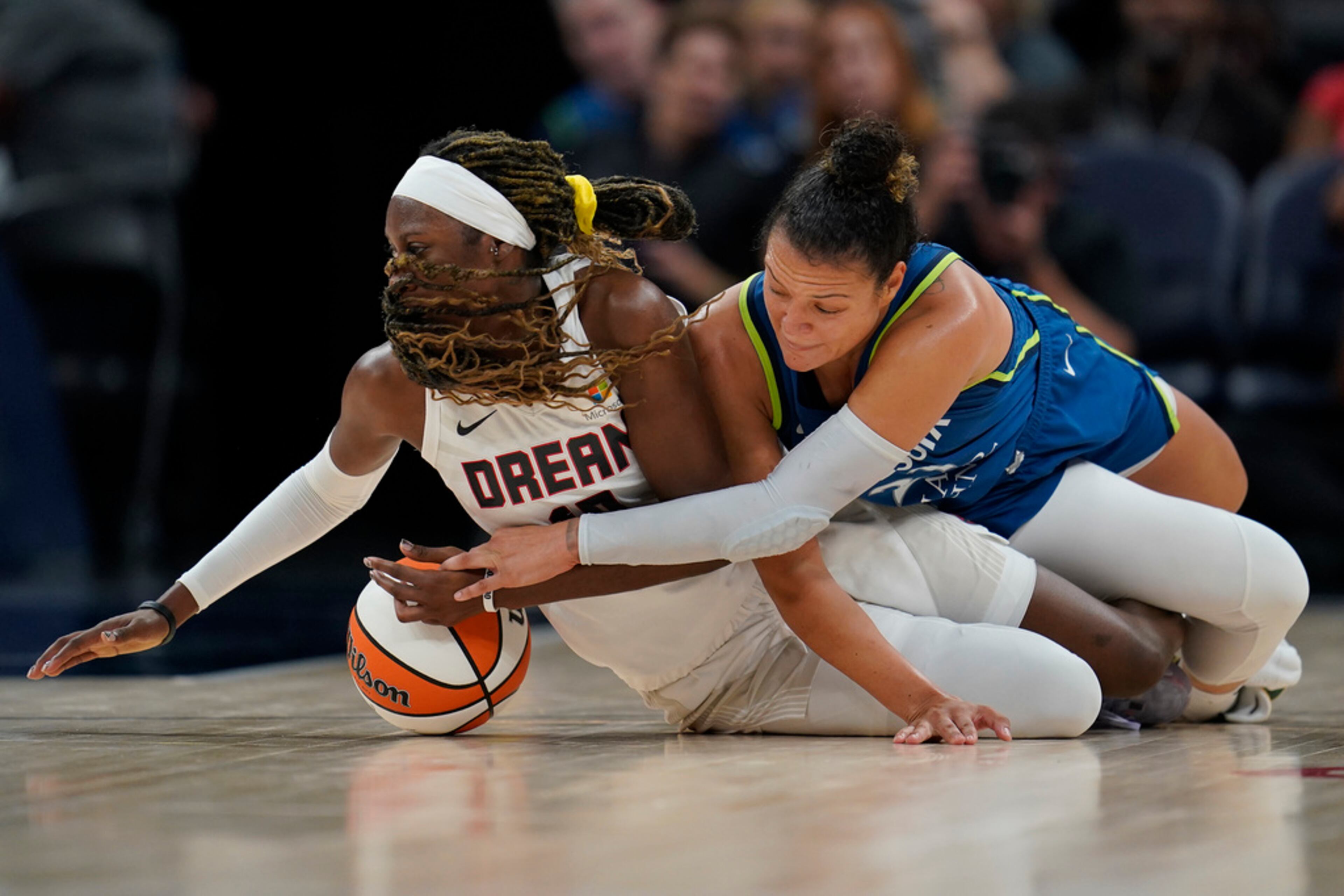 Atlanta Dream guard Rhyne Howard, left, and Minnesota Lynx guard Kayla McBride, right, battle for possession during the second half of a WNBA basketball game Friday, Sept. 1, 2023, in Minneapolis. (AP Photo/Abbie Parr)