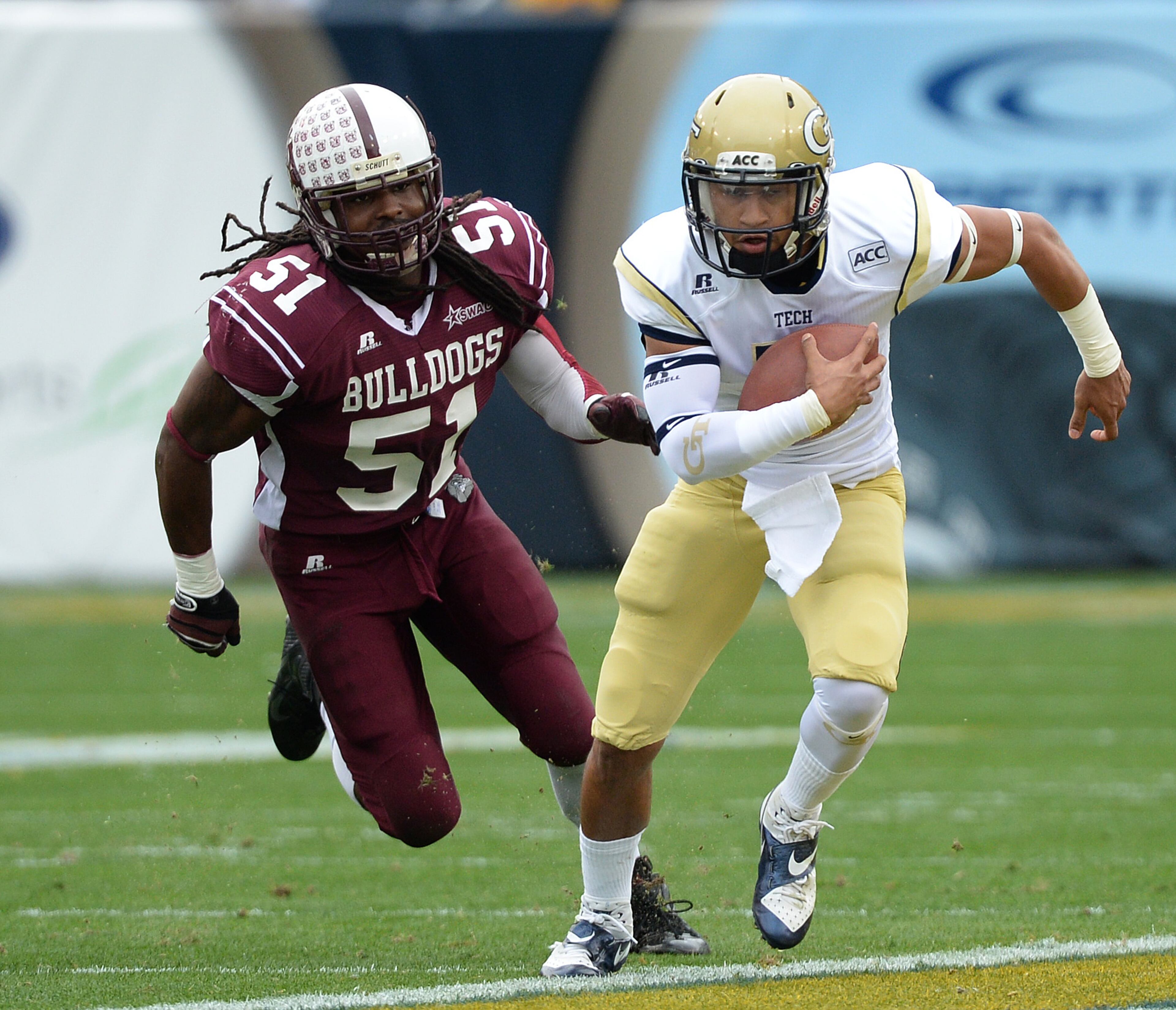 Georgia Tech's Justin Thomas (5) is chased by Alabama A&M's Robert Nelson (51) in the first half during the Georgia Tech vs. Alabama A&M football game in Bobby Dodd Stadium. Georgia Tech won the game 66 to 7.