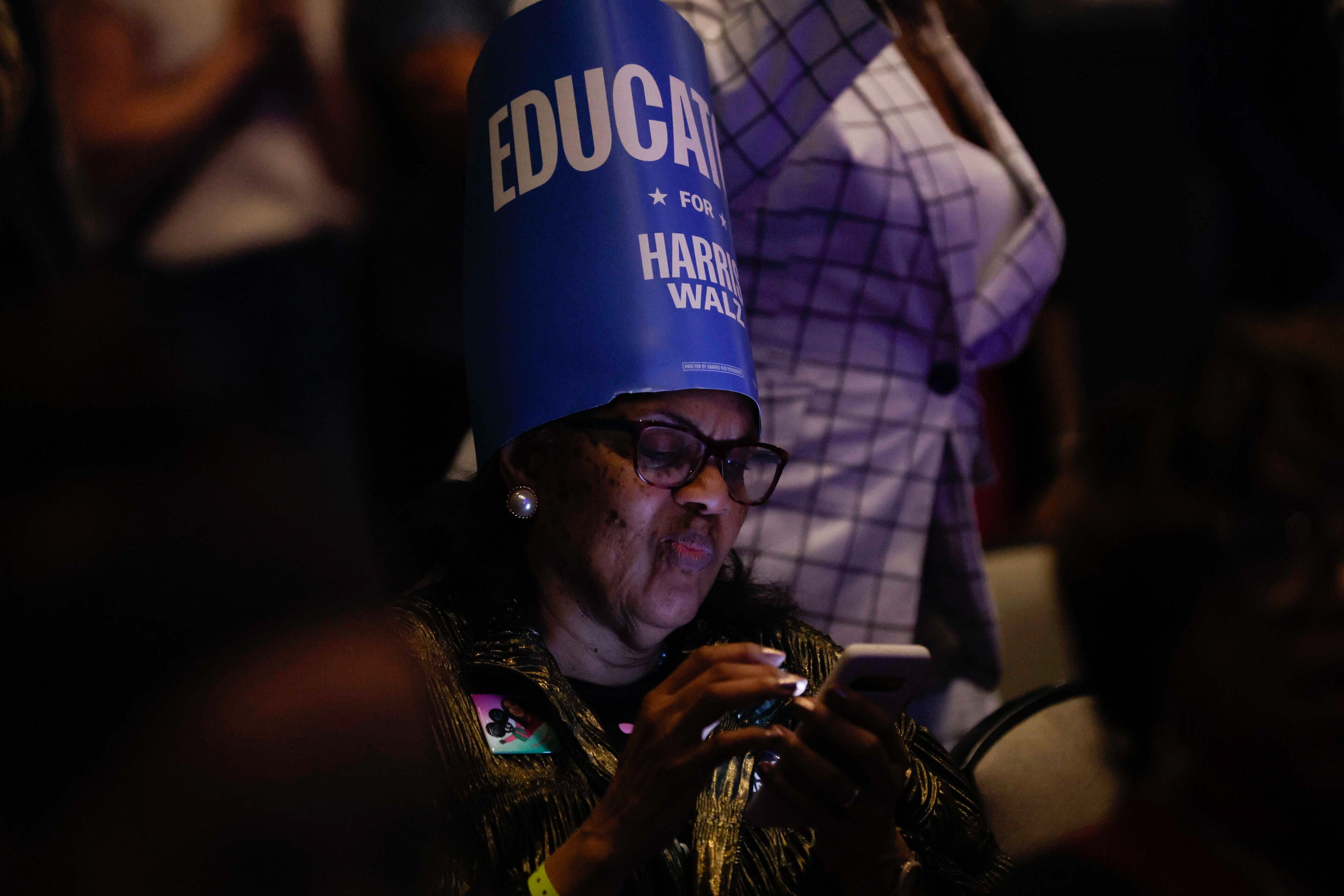 A Kamala Harris supporter follows the results on her phone as she awaits the next speaker during the Democratic election night watch party at the Hyatt Regency Hotel in downtown Atlanta on Tuesday, November 5, 2024, in Atlanta.
(Miguel Martinez / AJC)