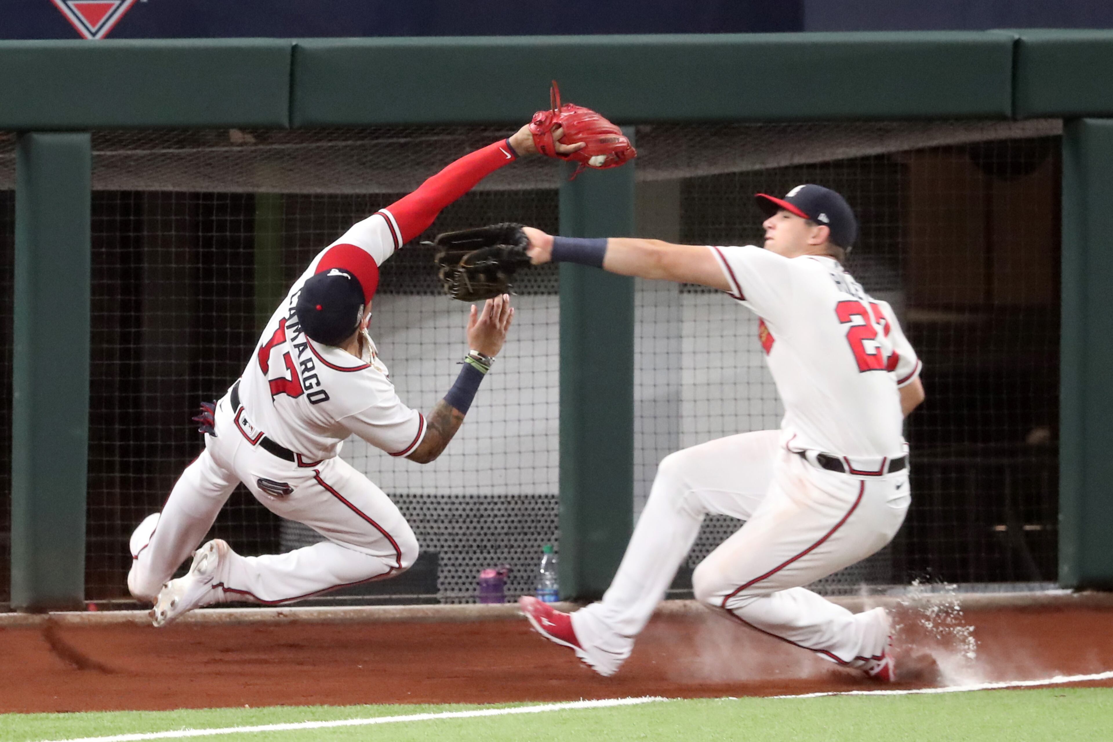 Braves third baseman Johan Camargo (left) avoids collision with left fielder Austin Riley as he makes a catch to get out Los Angeles Dodgers designated hitter Joc Pederson during the sixth inning Wednesday, Oct. 14, 2020, at Globe Life Field in Arlington, Texas. (Curtis Compton / Curtis.Compton@ajc.com)
