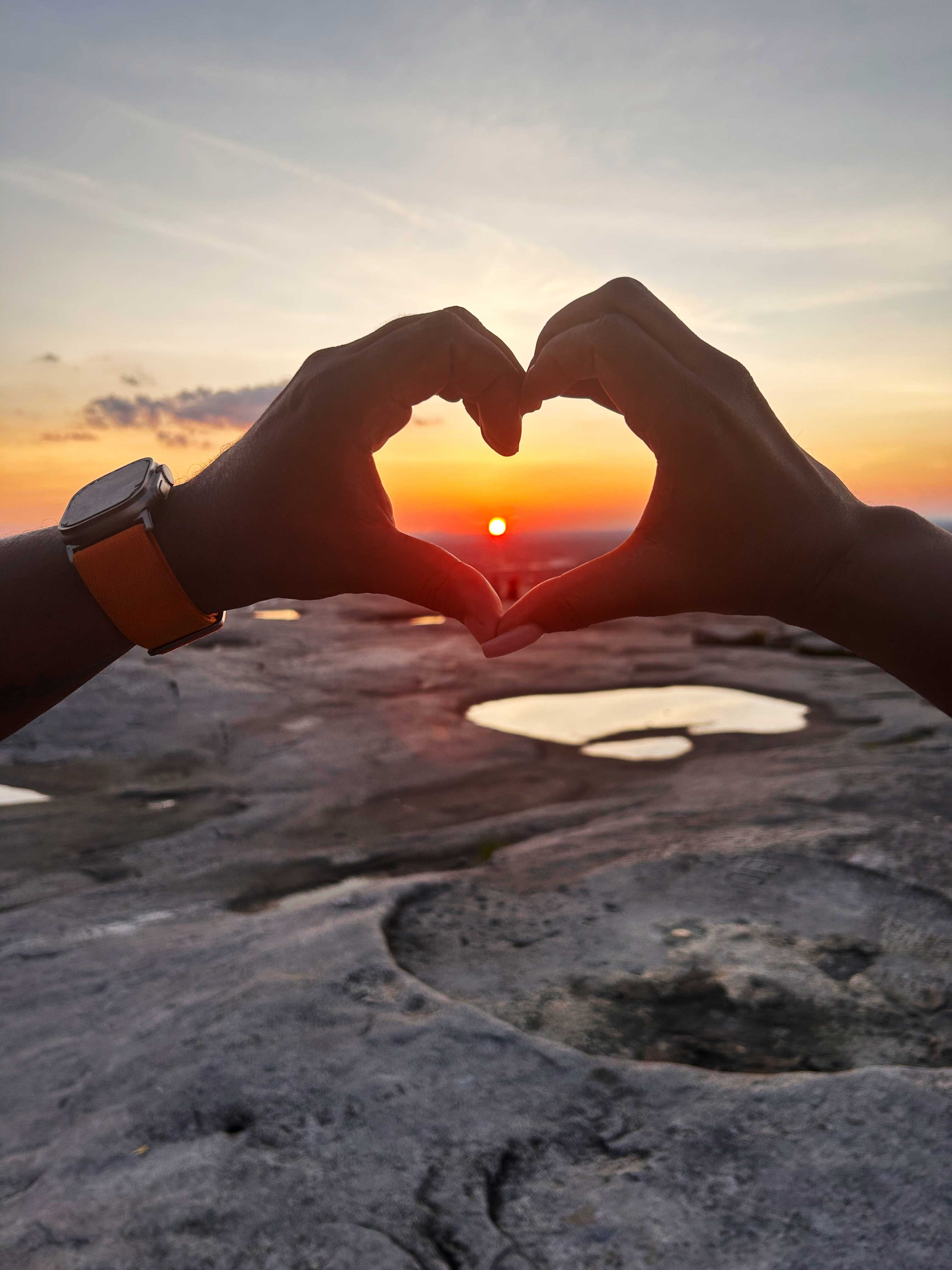 Near the end of the longest day of the year, Georgians rest atop Stone Mountain to watch the sunset behind the Atlanta skyline. (Courtesy of Monica Jones)