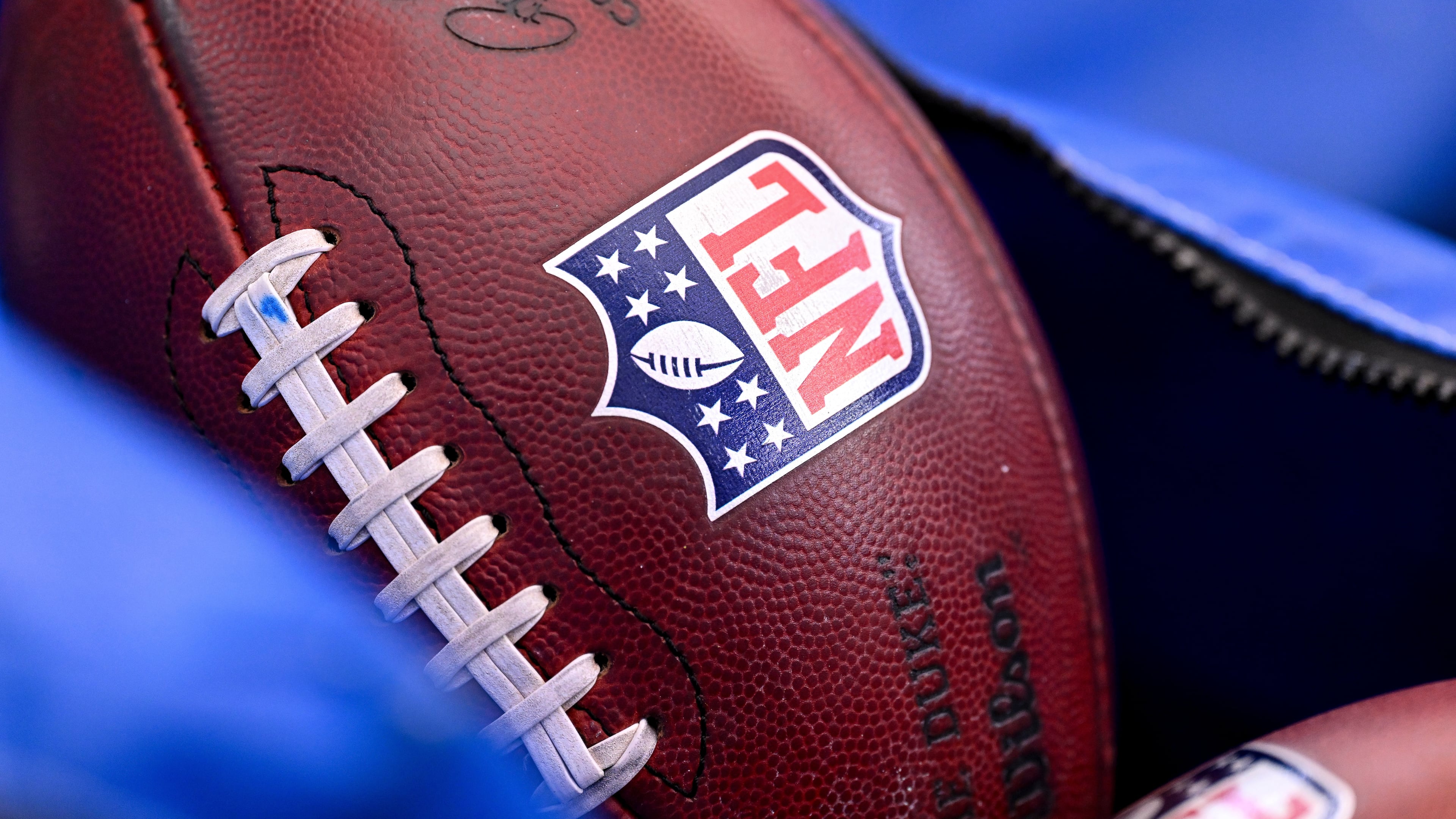 FILE - A detail view of the NFL shield on a football prior to an NFL football game between the Houston Texans and the Indianapolis Colts on Jan. 4, 2026, in Houston. (AP Photo/Maria Lysaker, File)