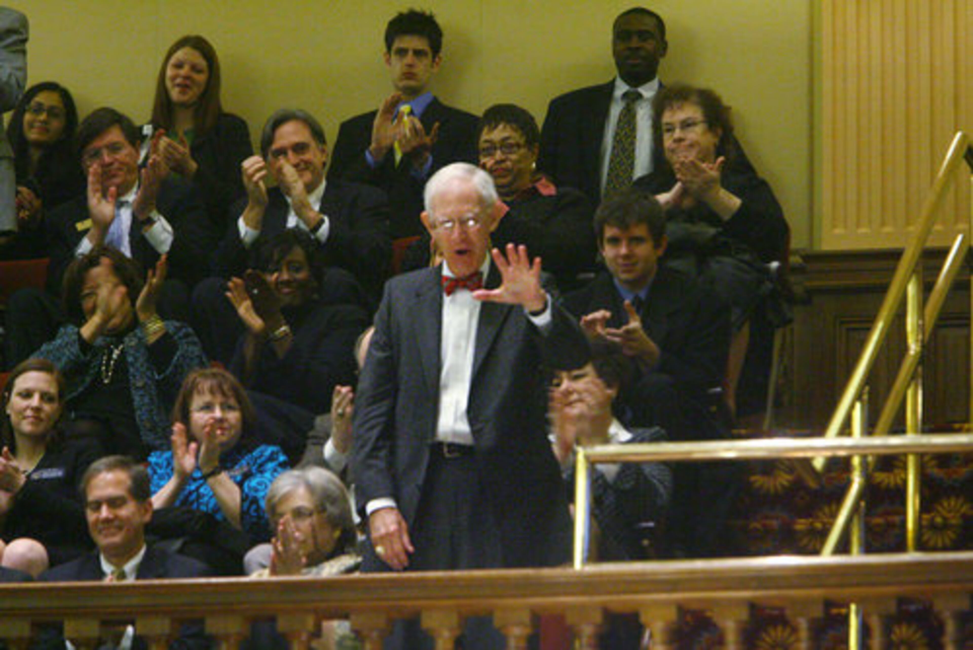 Retired former chief justice Norman Fletcher wavves from the audience after Chief Justice Leah Ward Sears thanked him during her address.
