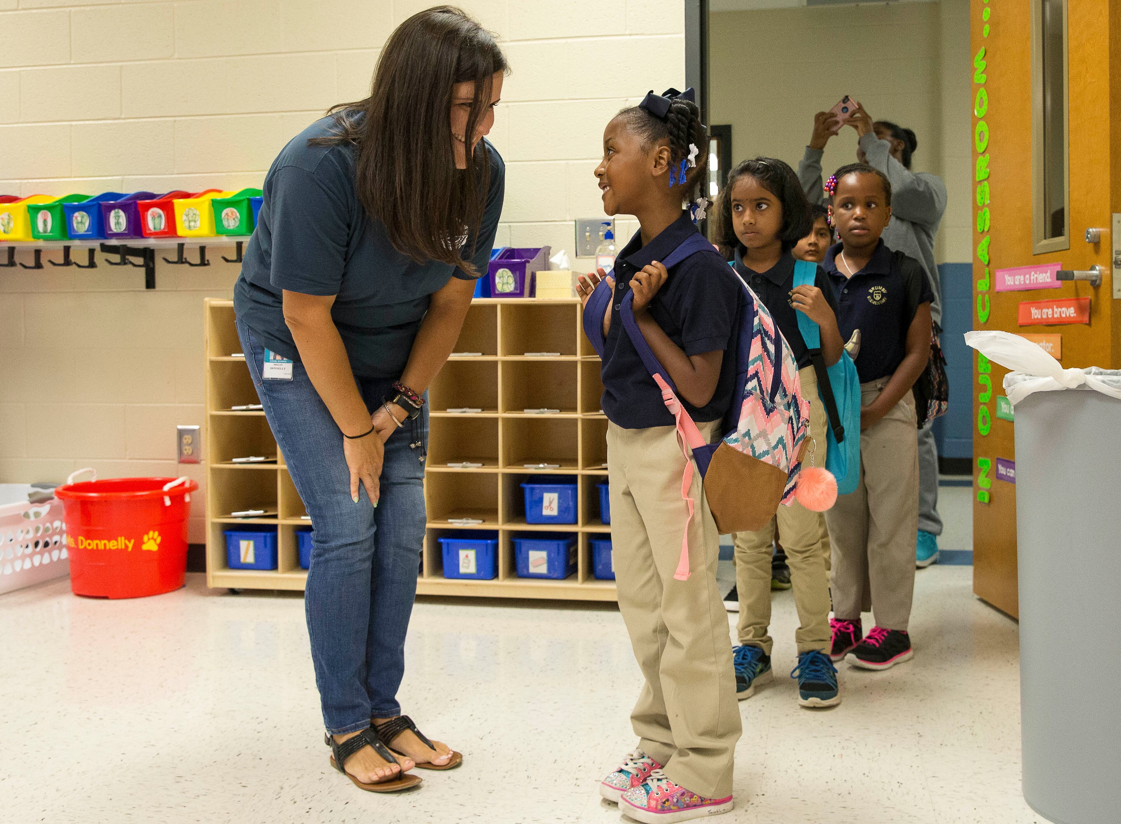 BACK TO SCHOOL (Cobb County) -- Marietta, Ga. --Second grade teacher Megan Donnelly (left) greets Aniya Bowden (right) during the first day of school at Brumby Elementary School in Marietta, Wednesday, August 1, 2018. (ALYSSA POINTER/ALYSSA.POINTER@AJC.COM)