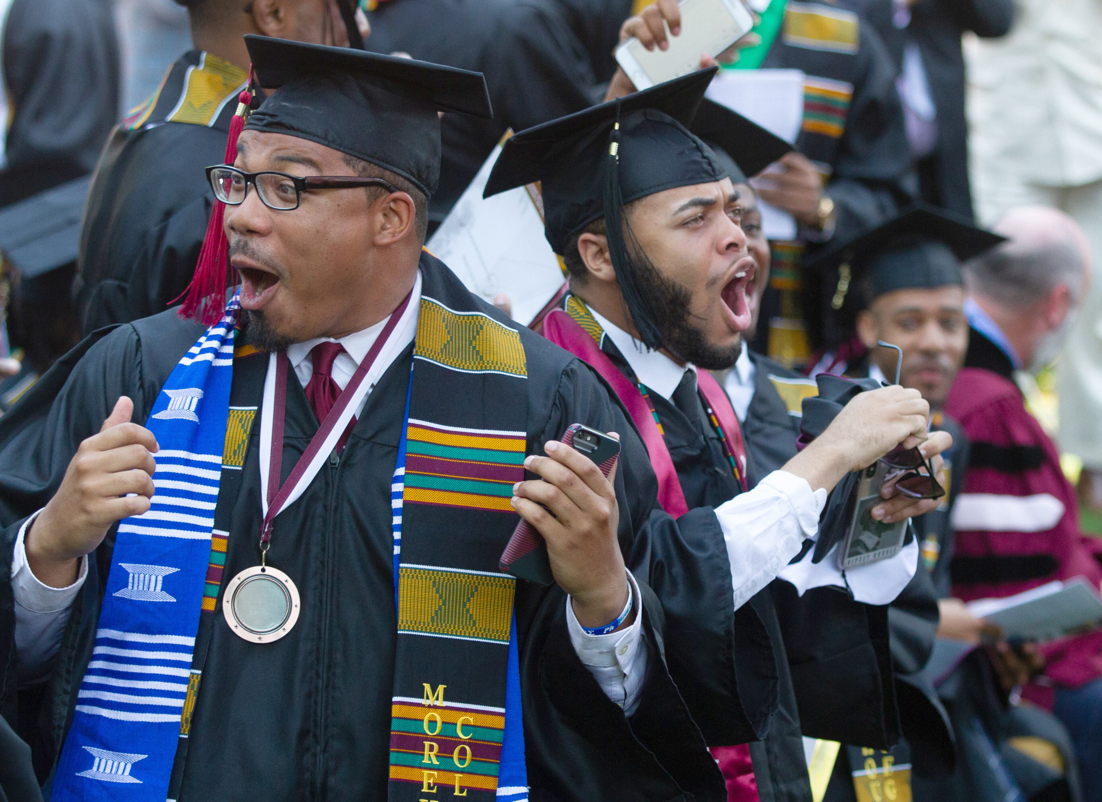 Graduates react after hearing billionaire Robert F. Smith is paying all student debt for the Class of 2019 during the Morehouse College commencement ceremony In Atlanta, on Sunday, May 19, 2019. (Photo: STEVE SCHAEFER / SPECIAL TO THE AJC)